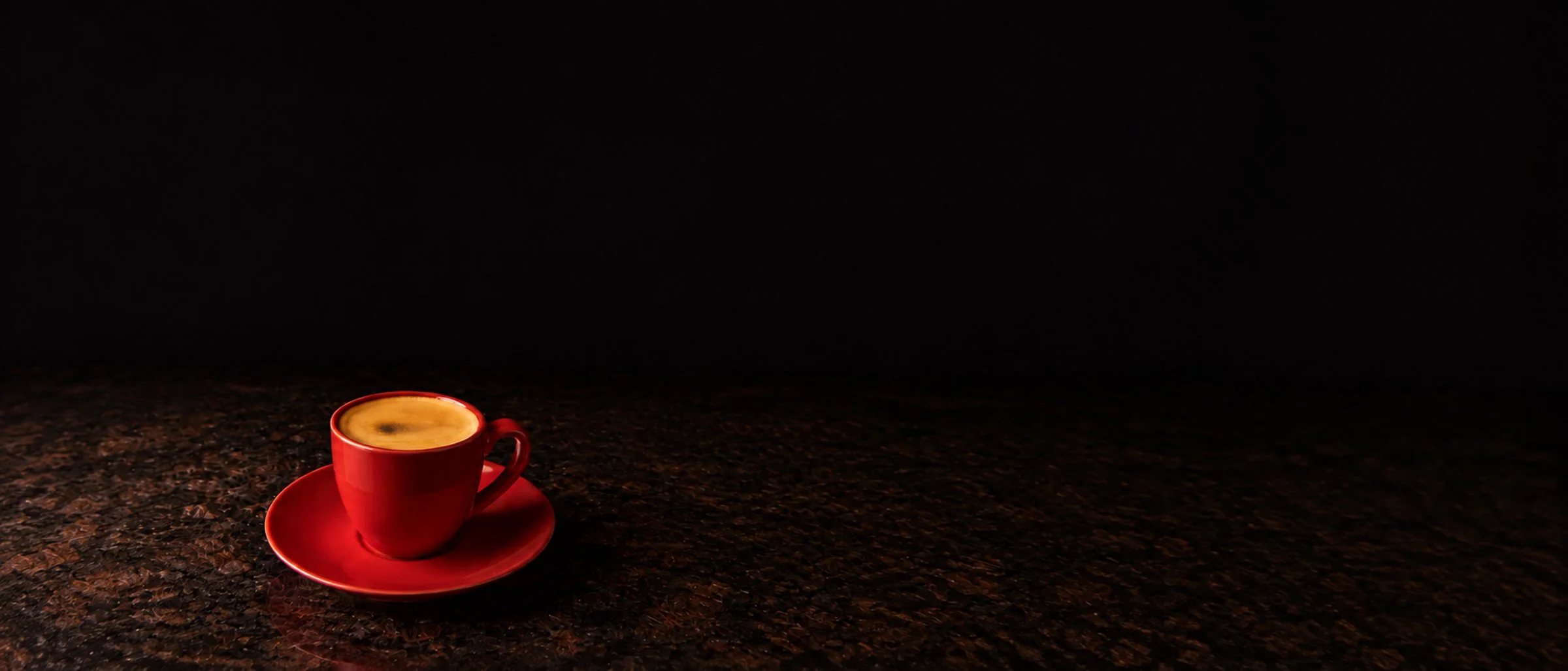 Espresso in a red cup on dark granite, Somerville food photography