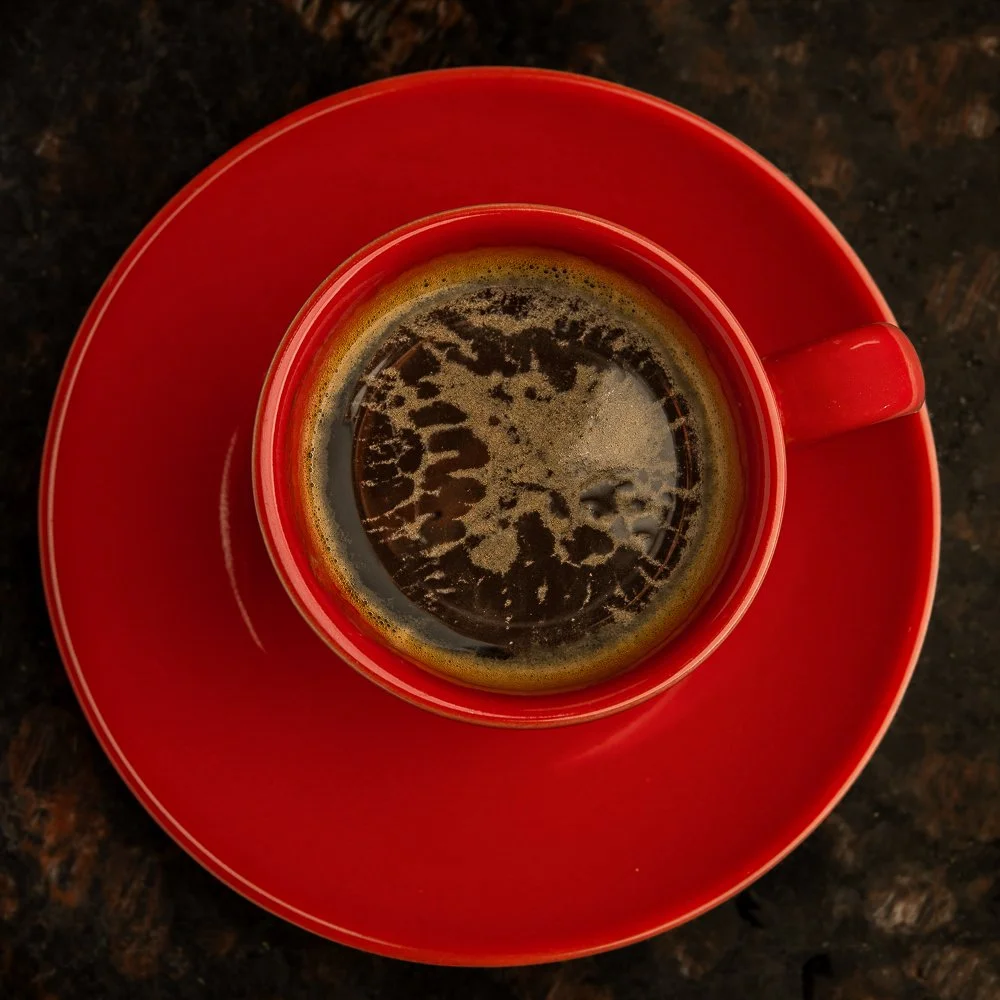 Espresso in a red cup photographed from above.