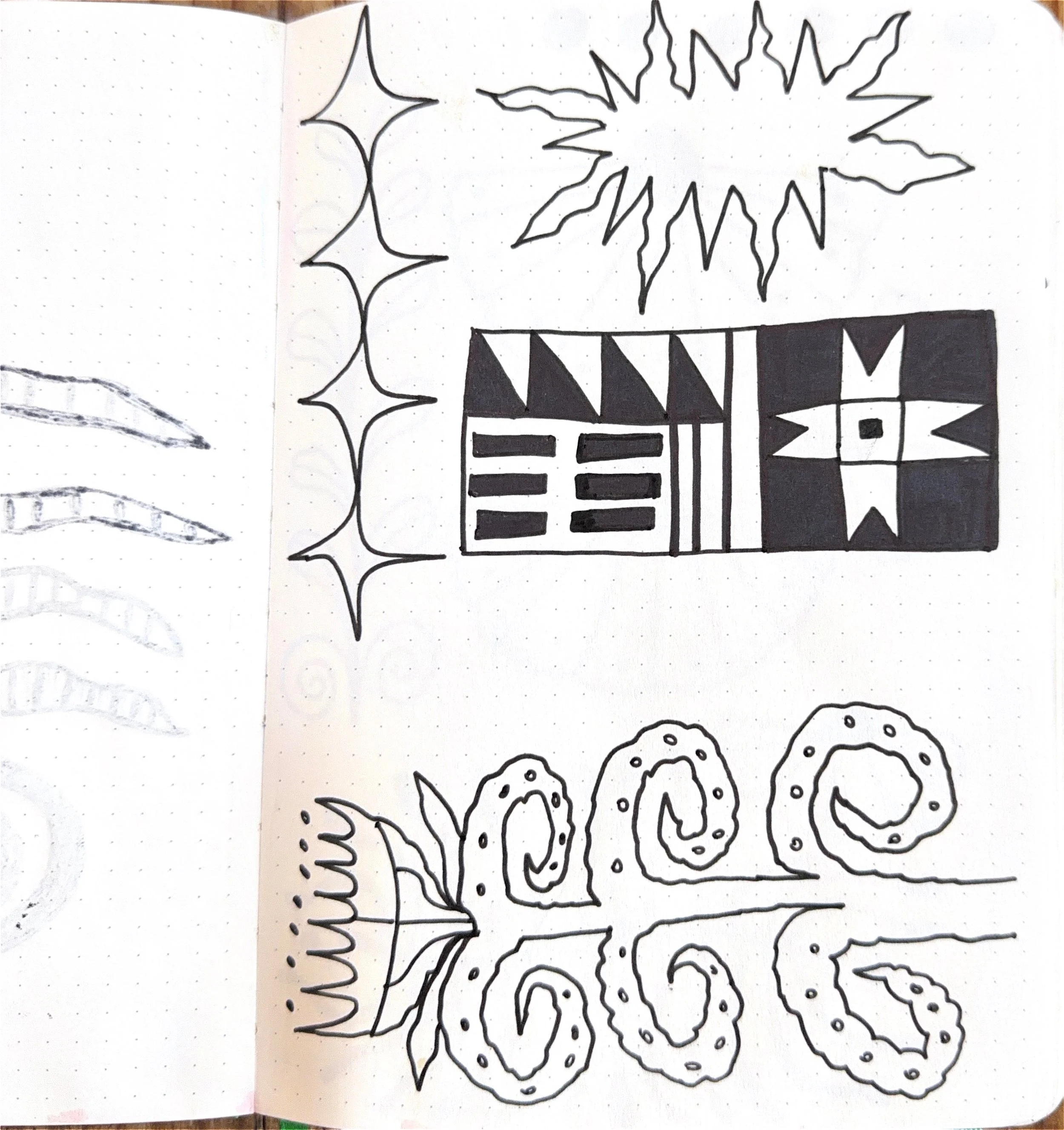 Black outlined floral and geometric patterns on white paper, including star-shaped flowers, a butterfly, and a grid of circles with dots.