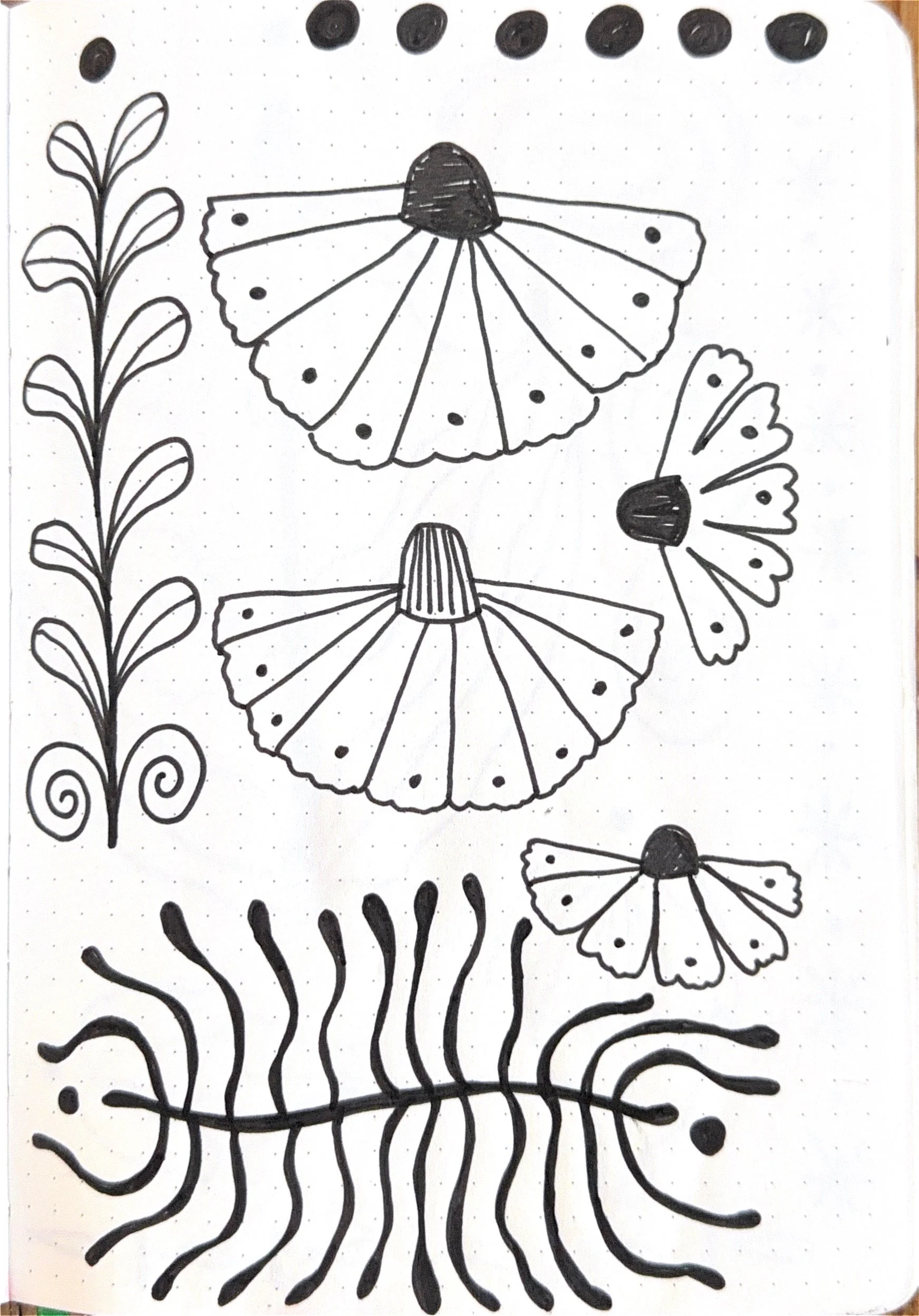 Black and white drawing of three butterflies, a plant, and wavy lines on paper.