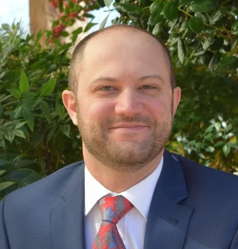 Attorney Mahmoud Khatib, with a neatly trimmed beard and an elegant suit and tie, has a friendly and sincere smile.