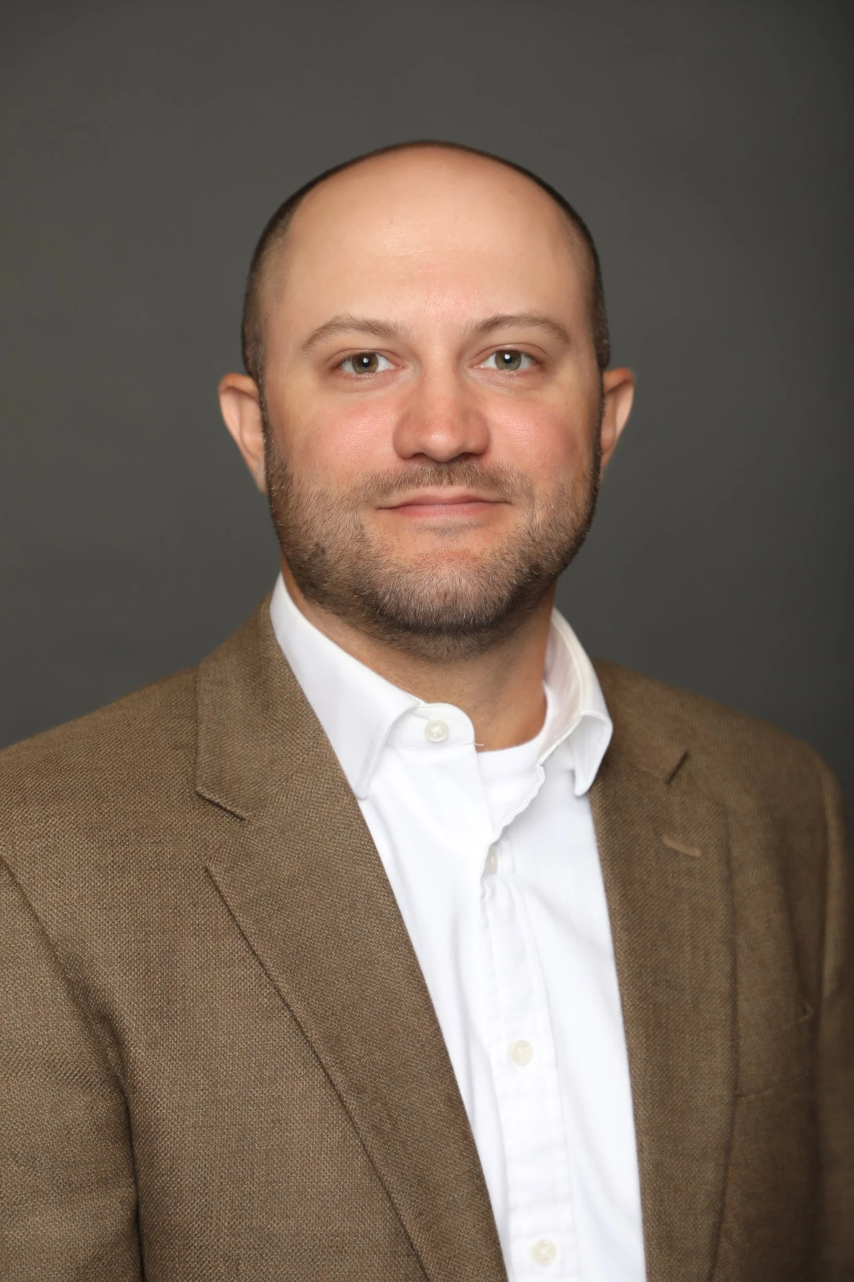Attorney Mahmoud Khatib, with a neatly trimmed beard and a light brown suit, has an honest and approachable smile.