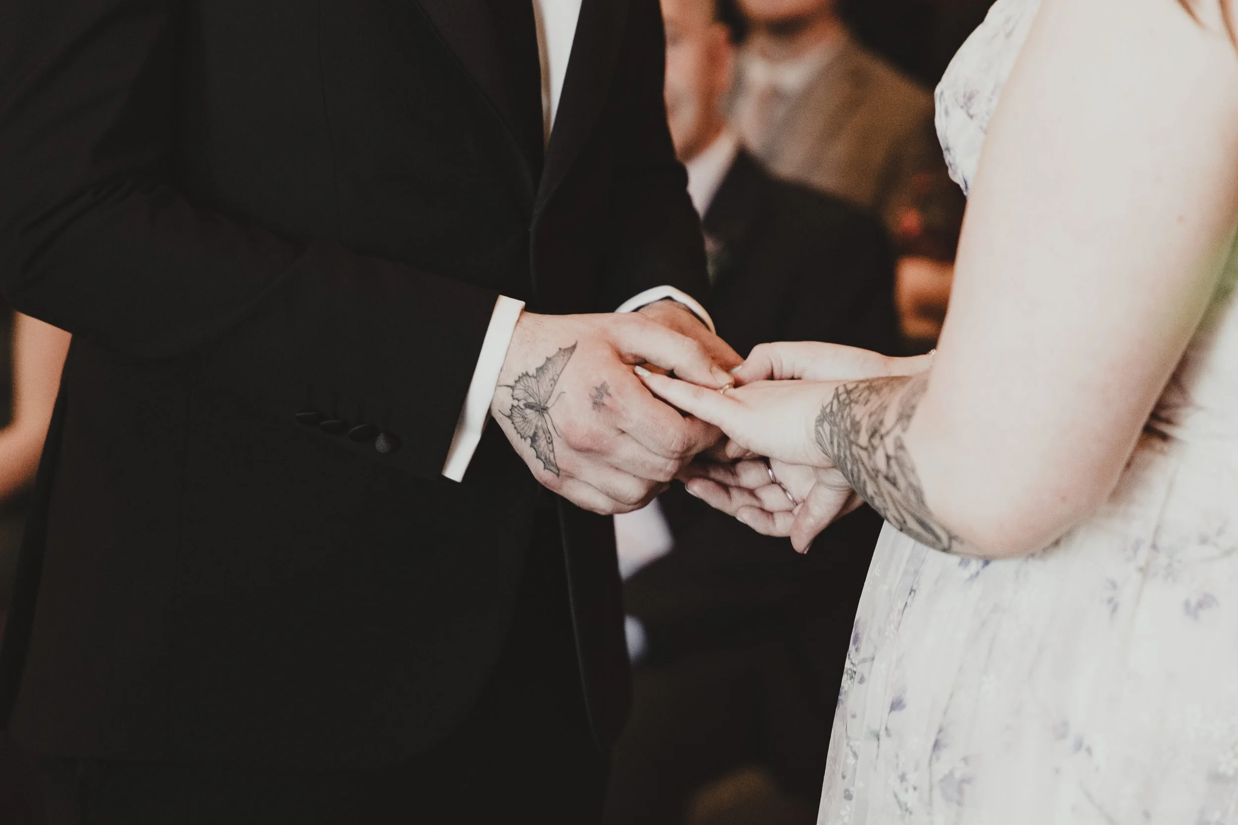 A man and woman exchanging rings during a wedding ceremony.
