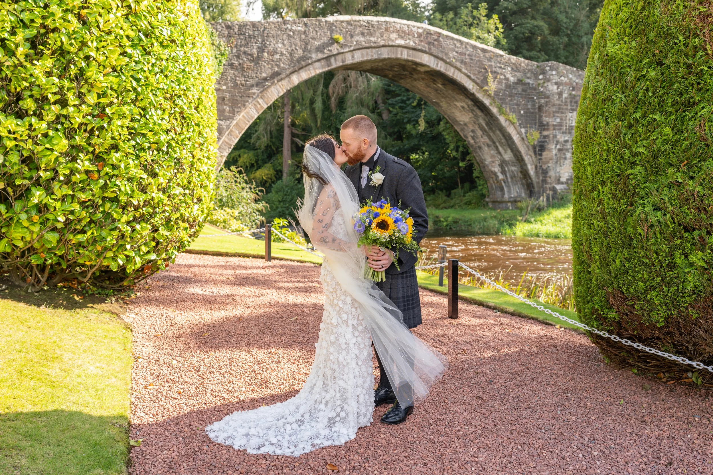 Bride and Groom kissing under the Brig o Doon.