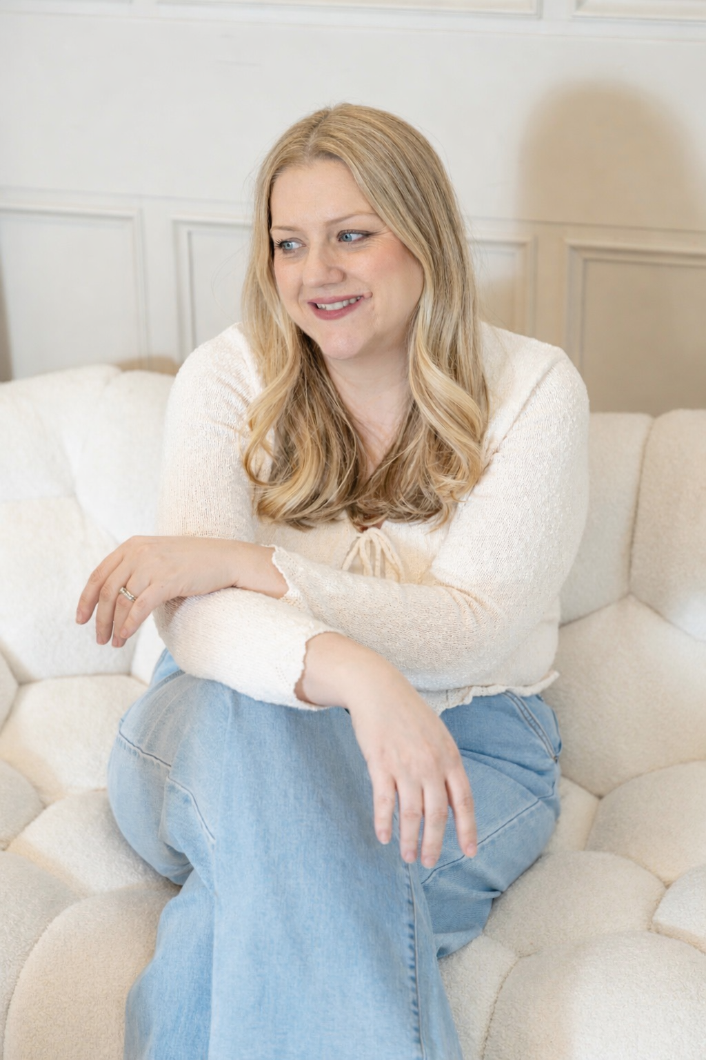 LAUREN CAMPBELL photography sitting on a seat posing for an image.