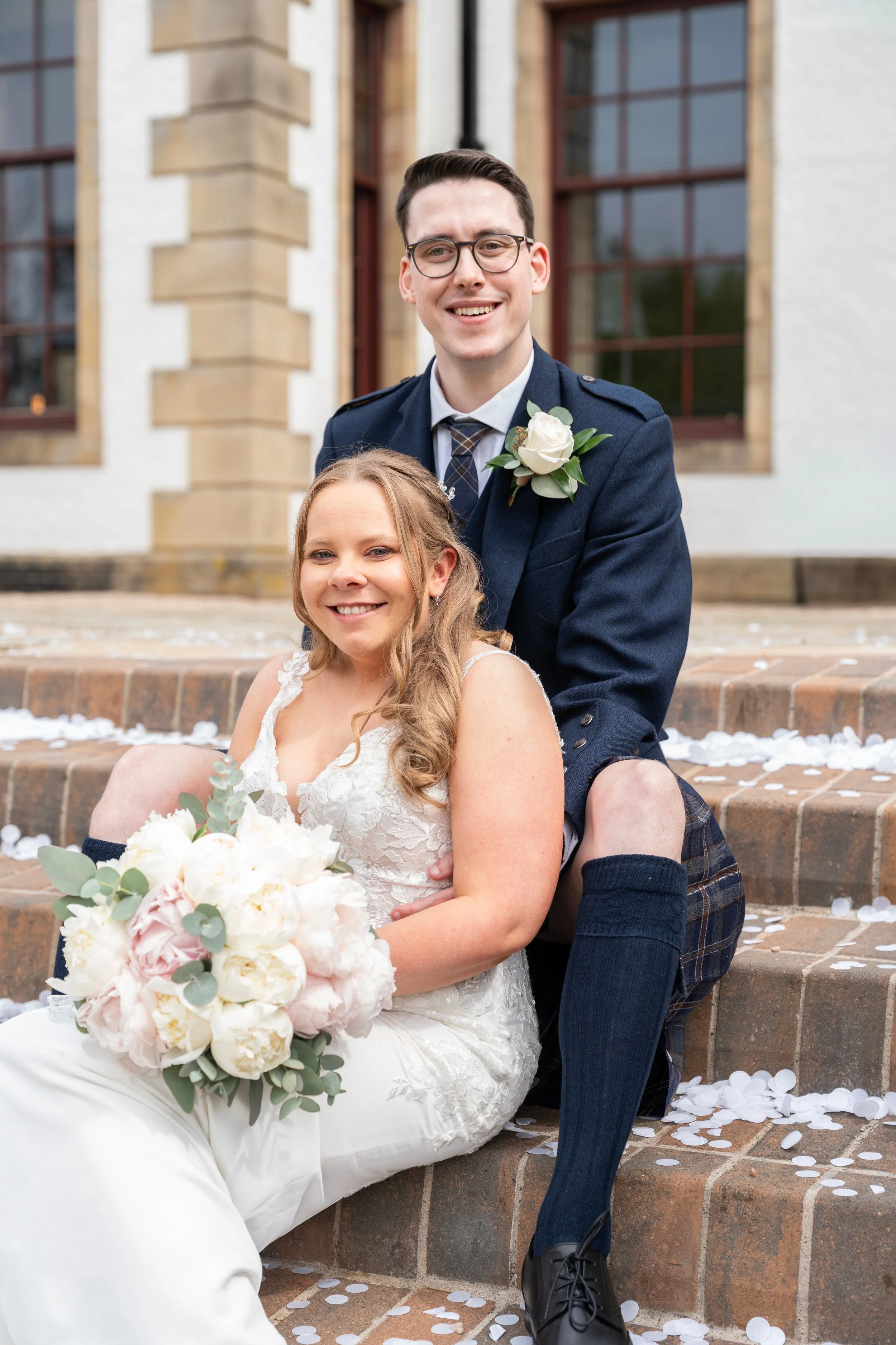 bride_and_groom_laughing_on_stairs_at_gleddoch_spa.jpg