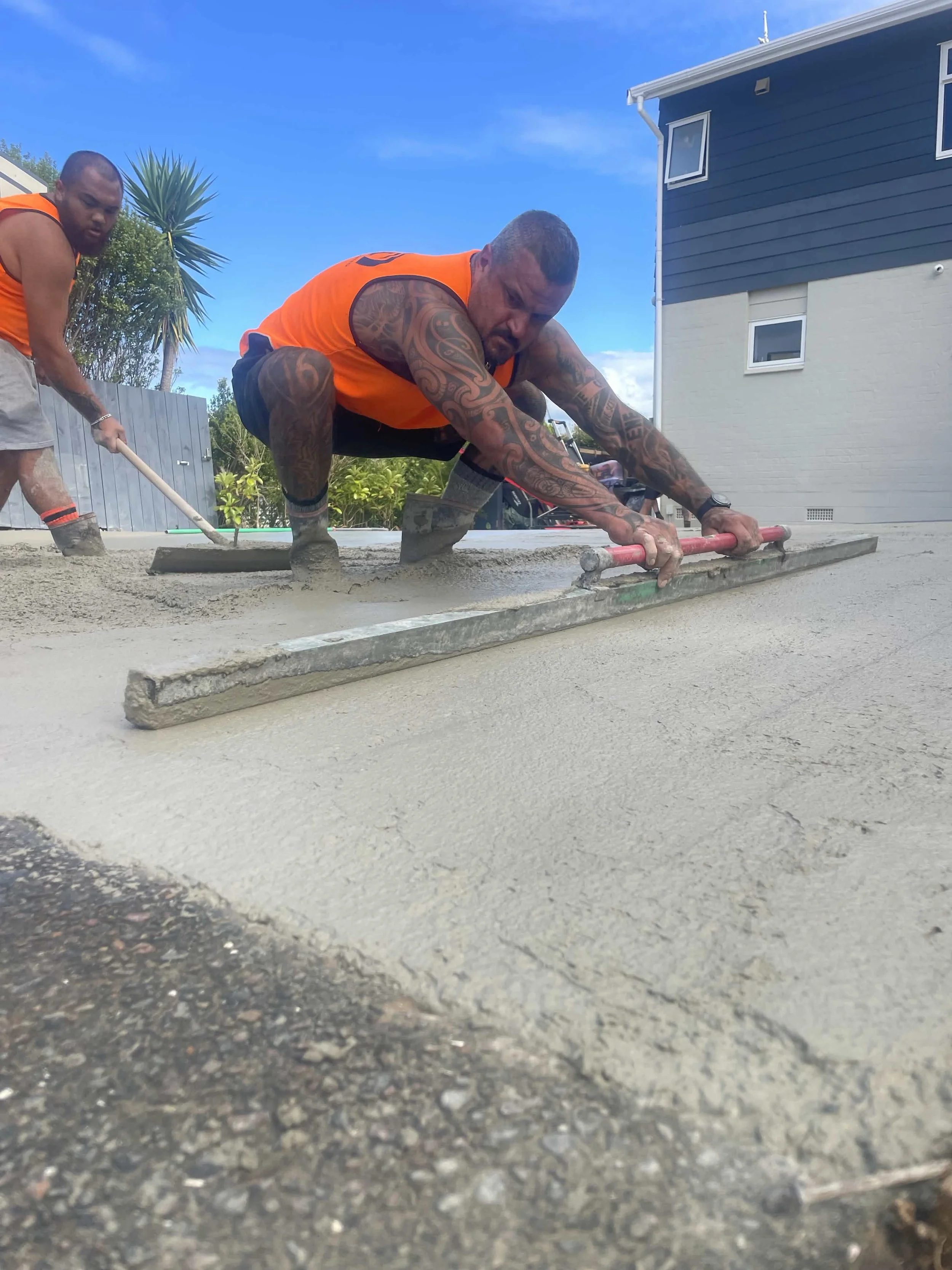 Concrete layers installing coloured concrete driveway
