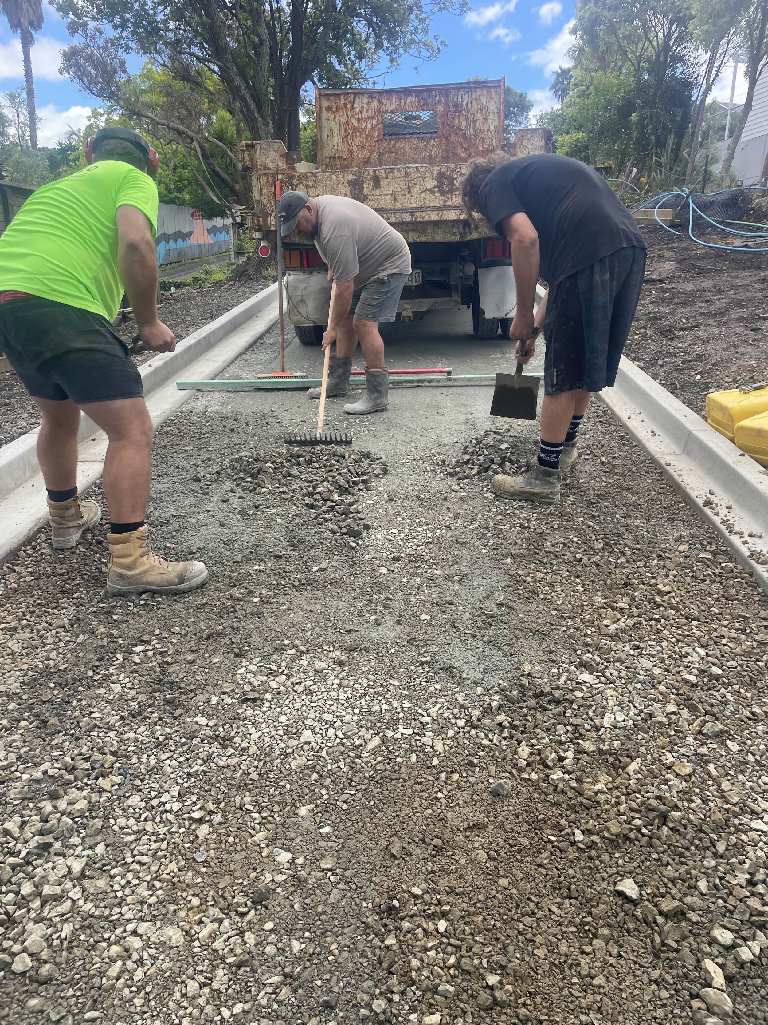 Team prepping/leveling driveway before Asphalt is poured