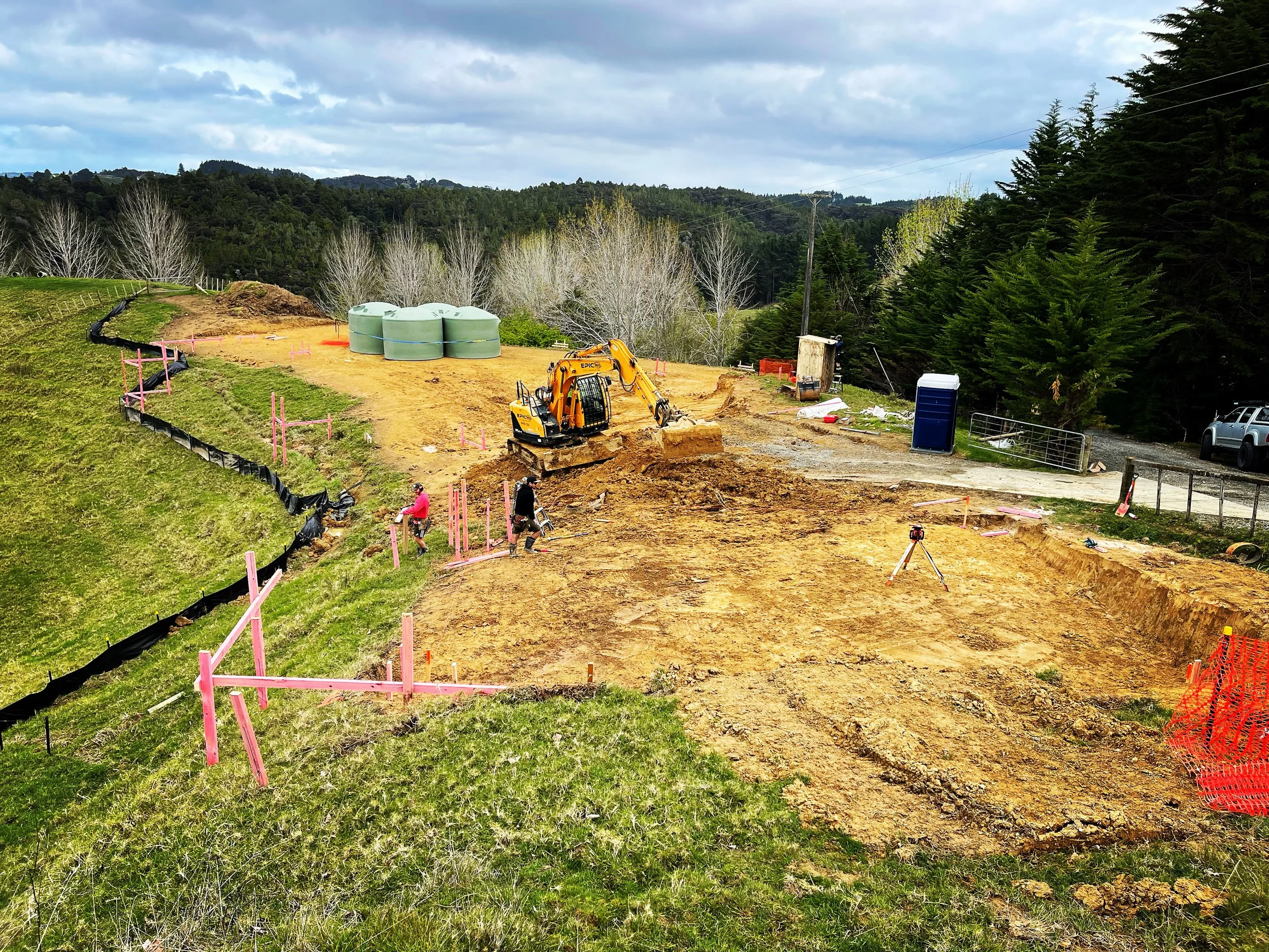 Construction site with Digger, creating a flat area for builders to lay foundations for a new house build