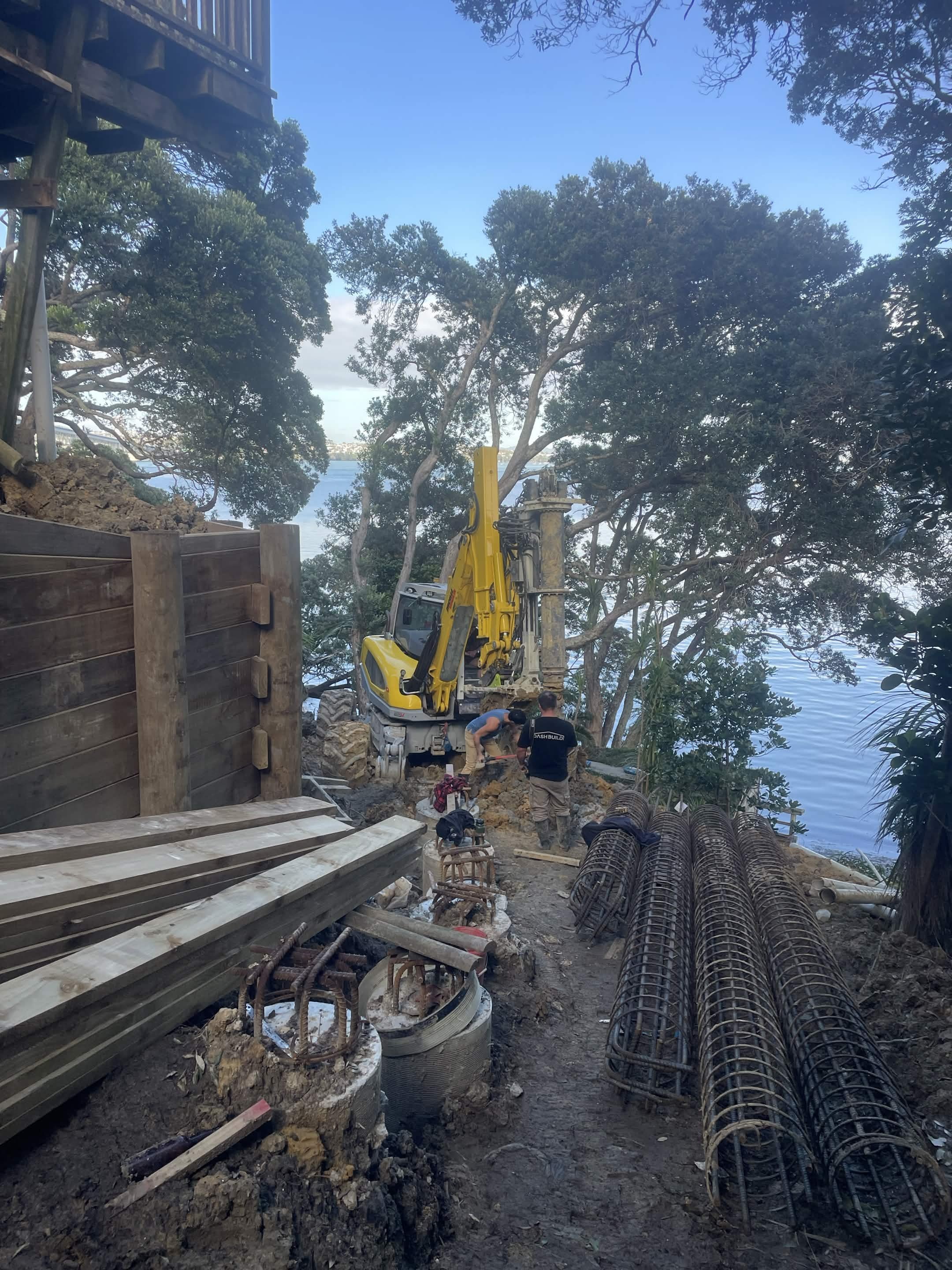 Construction of a palisade retaining wall to stop further erosion of the cliff to secure they house above doesn't collapse down the bank.