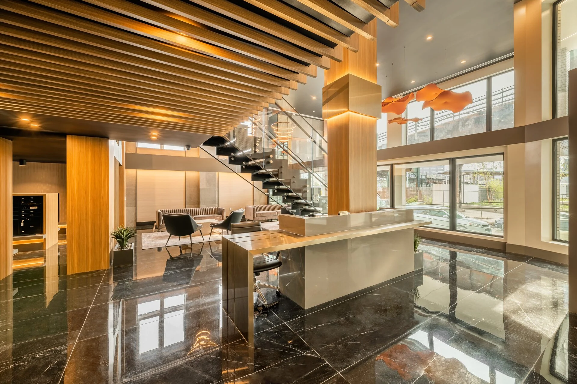 Modern hotel lobby interior with wooden accents, glass staircase, large windows, and contemporary lighting fixtures.