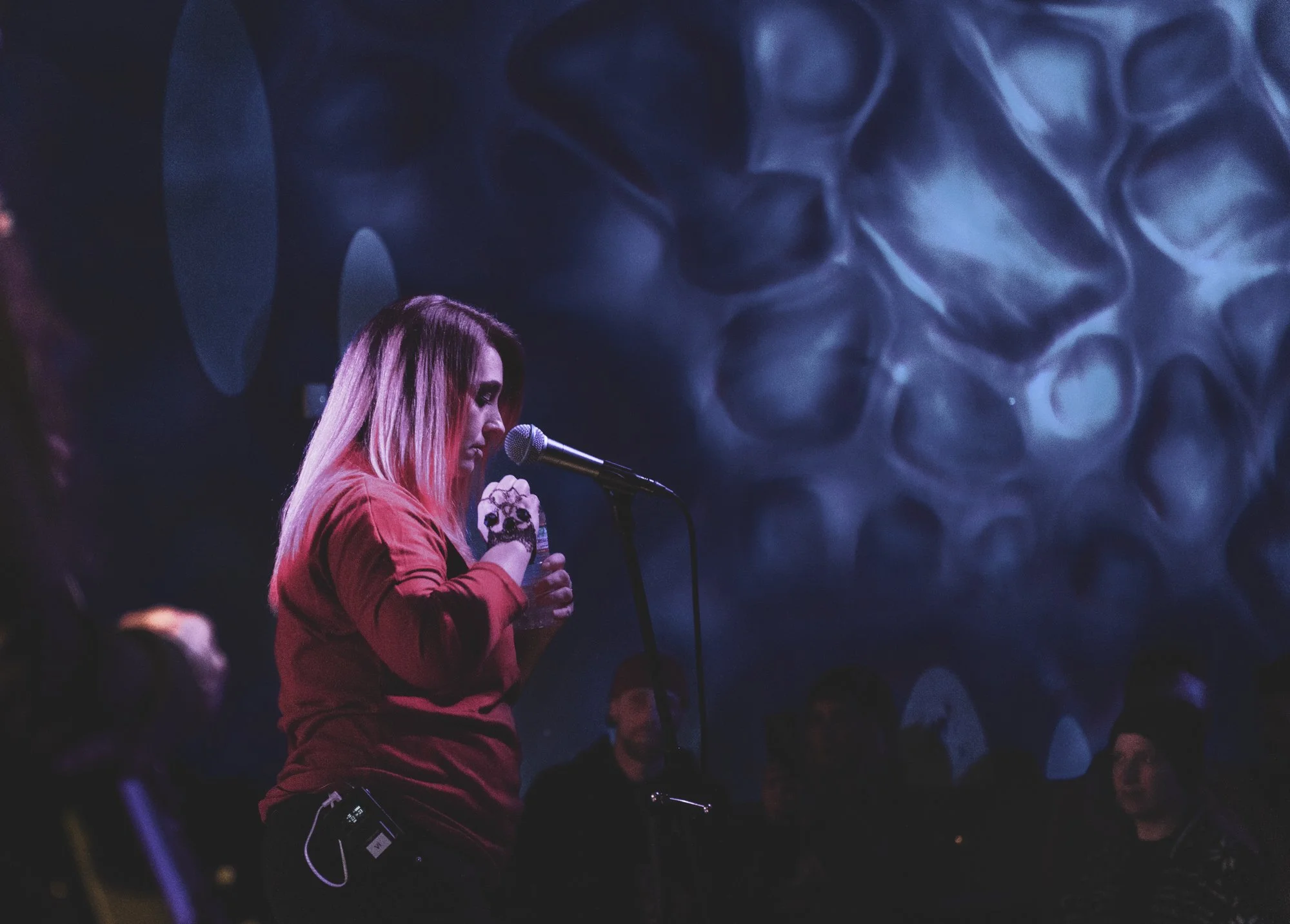 a female singer pausing having an emotional moment during a concert