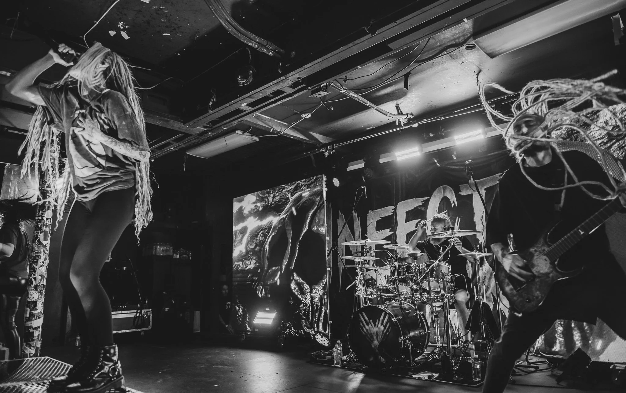a black and white concert photo of a band performing in a PNW venue