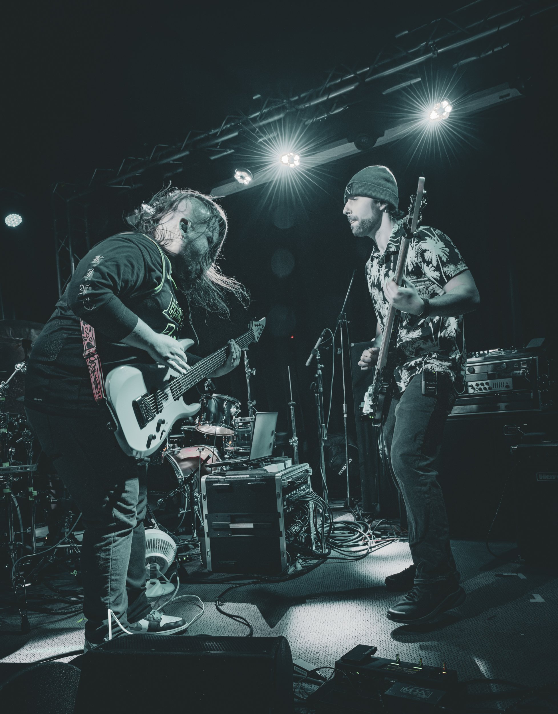 a guitarist and bassist jamming out on stage