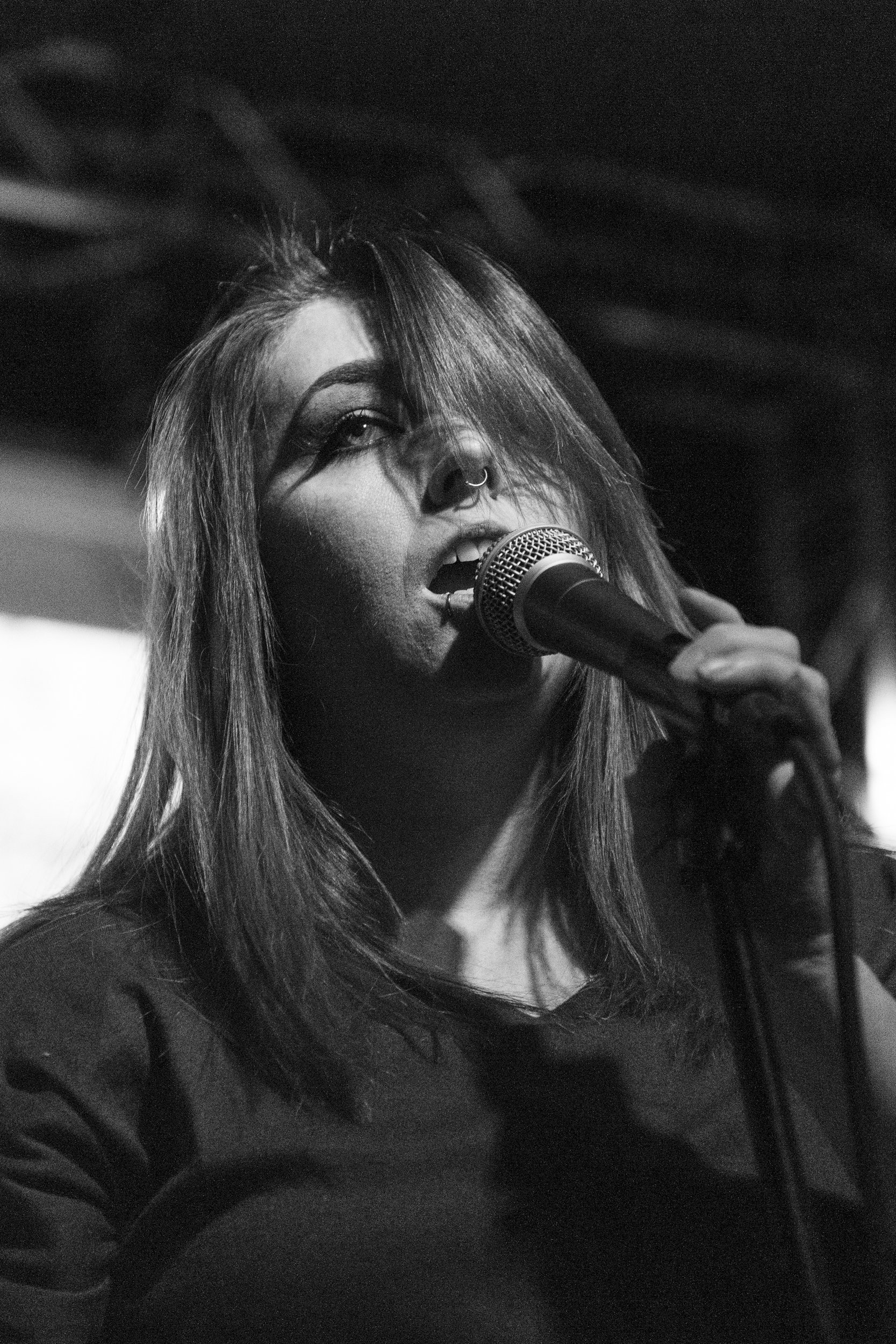 a black and white photograph of a woman singing