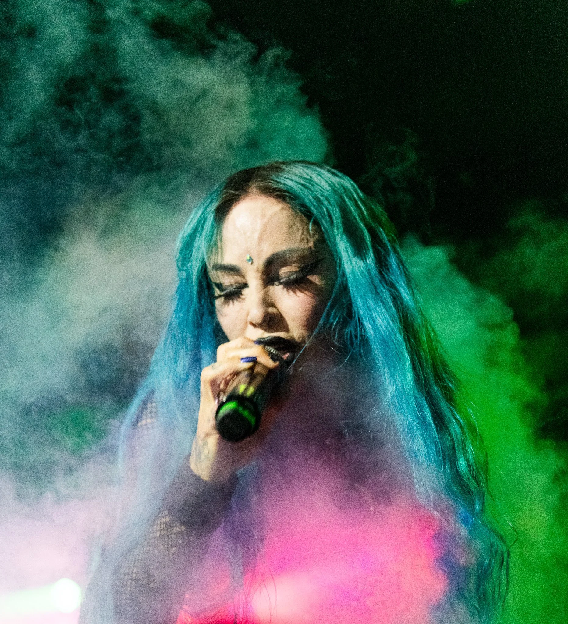 a singer performing in haze