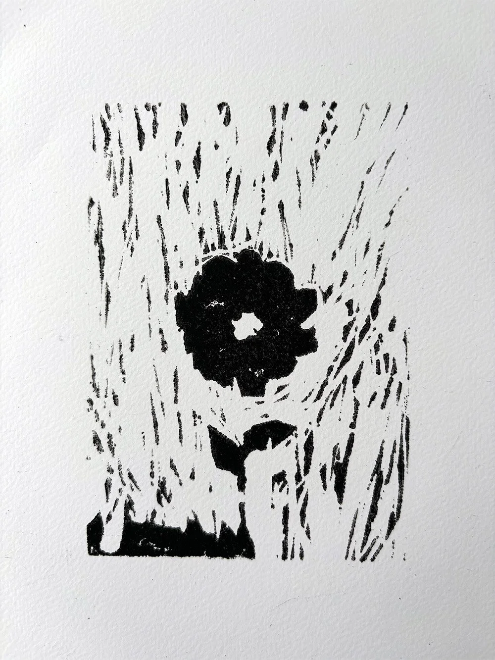 A black and white lino print of a flower with rain or streaks in the background.