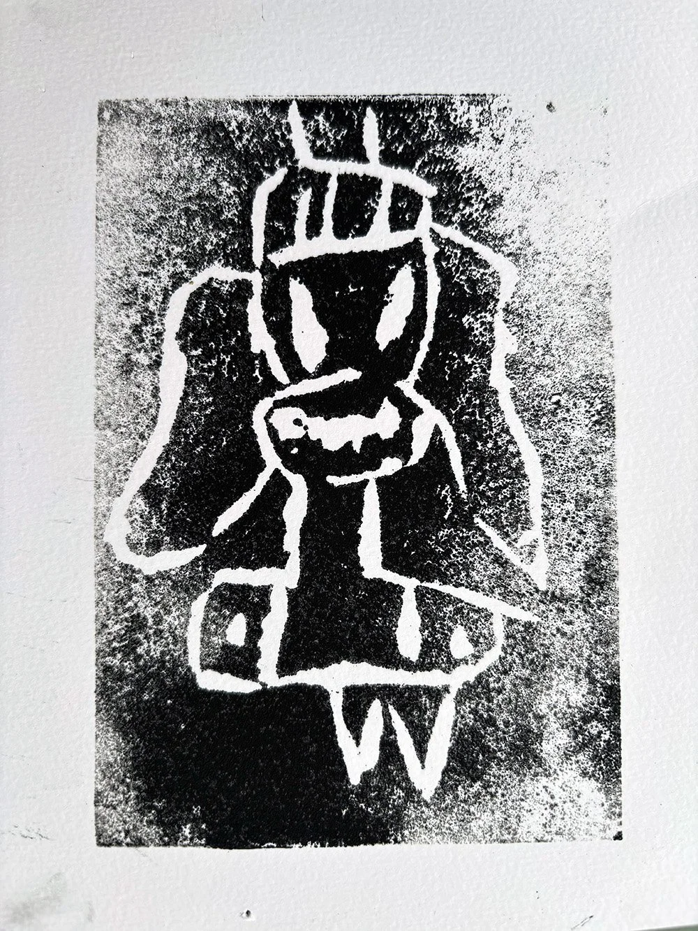 A black and white lino print  of a bull's head with large horns, with an upward-pointing arrow and the letter 'V' below it.