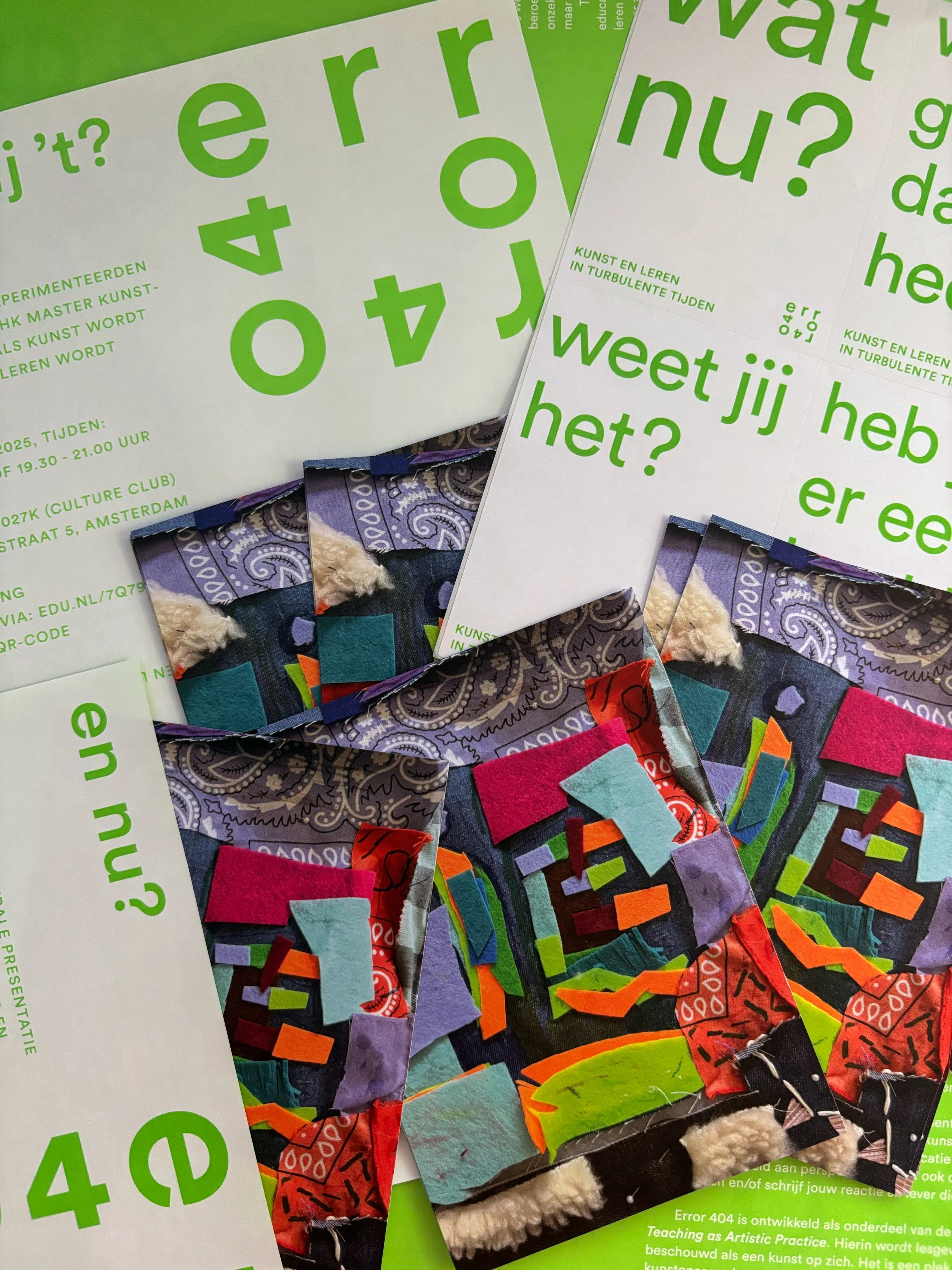 Close-up photograph of colorful exhibition flyers or posters with Dutch text, featuring large green and purple typography, smaller green text, and assorted fabric or paper samples attached at the bottom.
