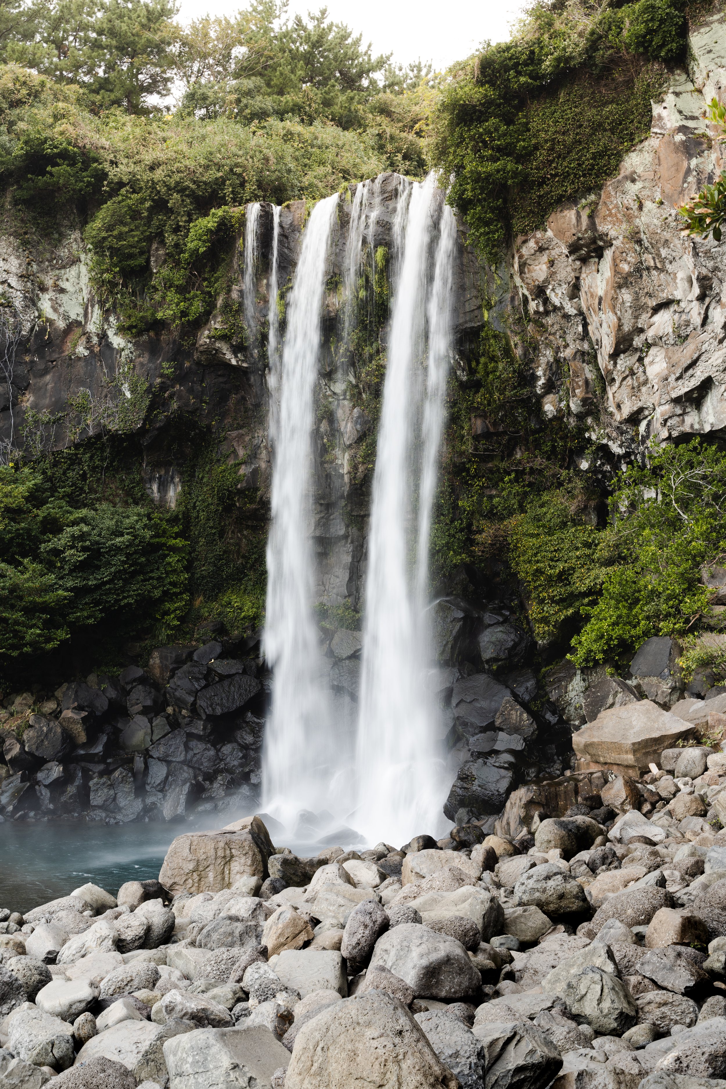 Jeongbang Falls, Jeju Island, South Korea — One of the few waterfalls in Asia that drops directly into the sea. The rocks hold their ground.