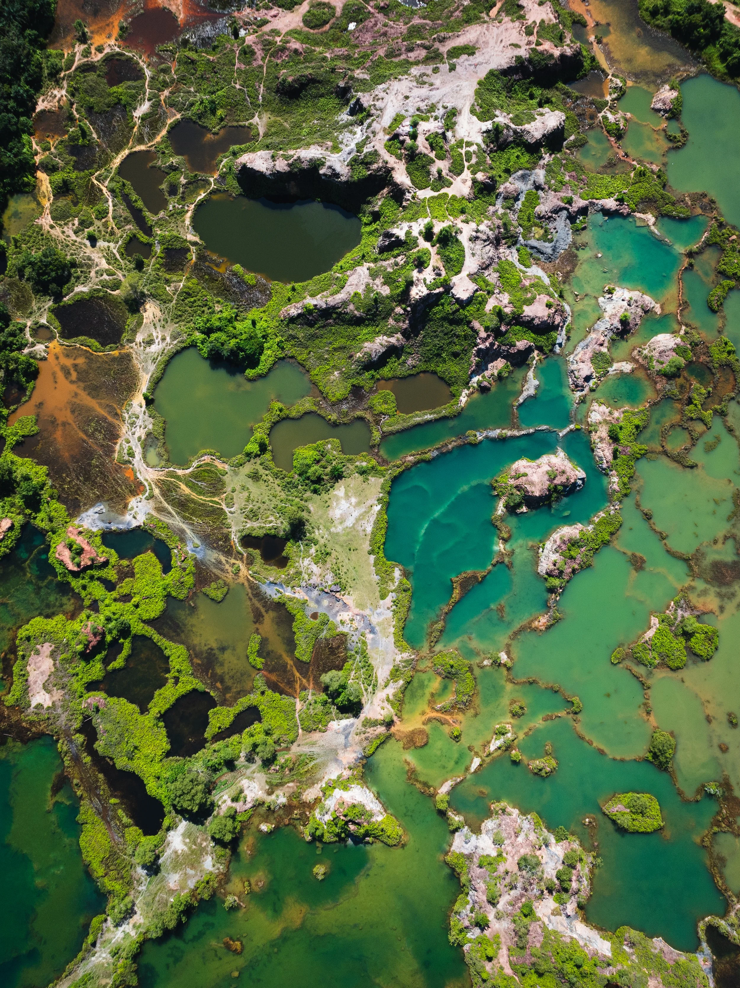 Frog Hill, Penang, Malaysia — Turquoise and jade quarry pools across fractured limestone, seen from directly above. Nature reclaiming what industry left behind.