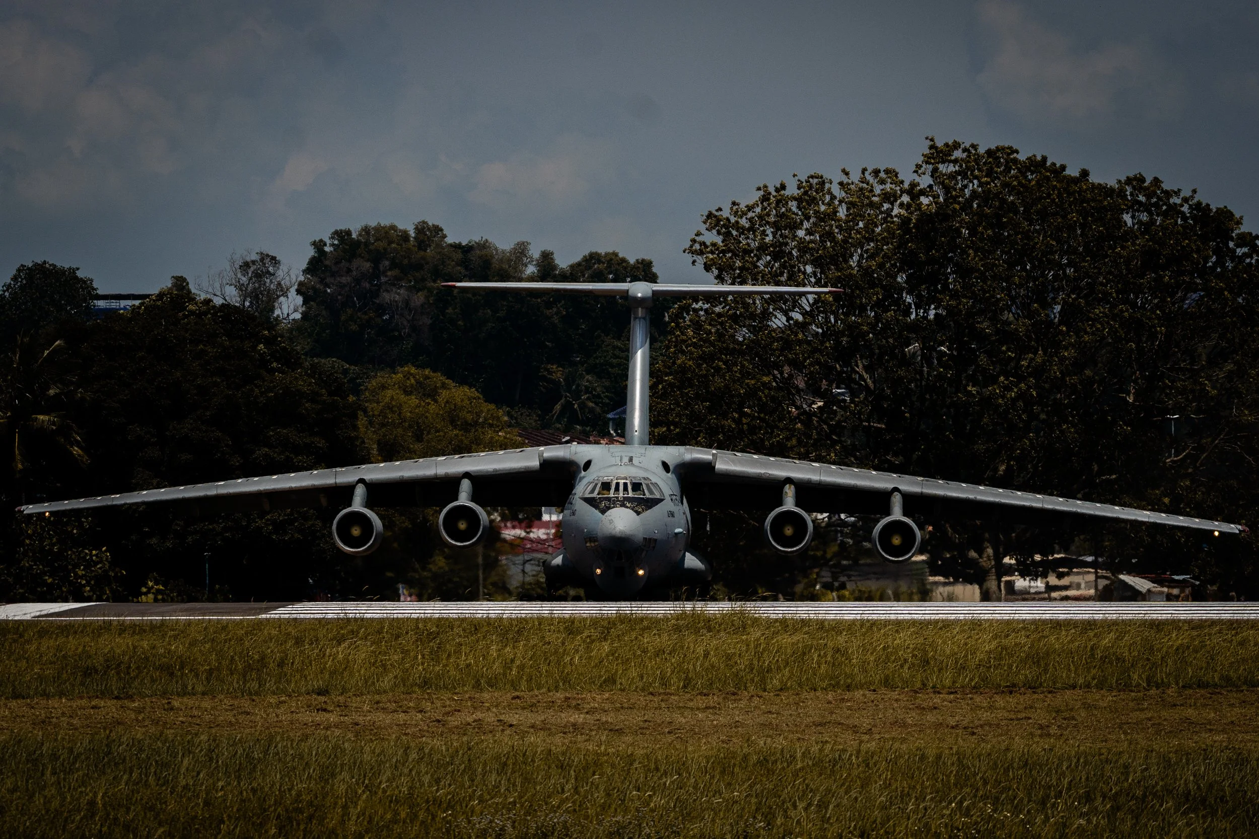 Indian Air Force Ilyushin IL-76, Subang (SZB), Selangor — The IL-76 taxies head-on toward the threshold, four engines idling, wings spanning the full width of the frame. A rare visitor to Malaysian skies, framed against the green hills of Subang. Low