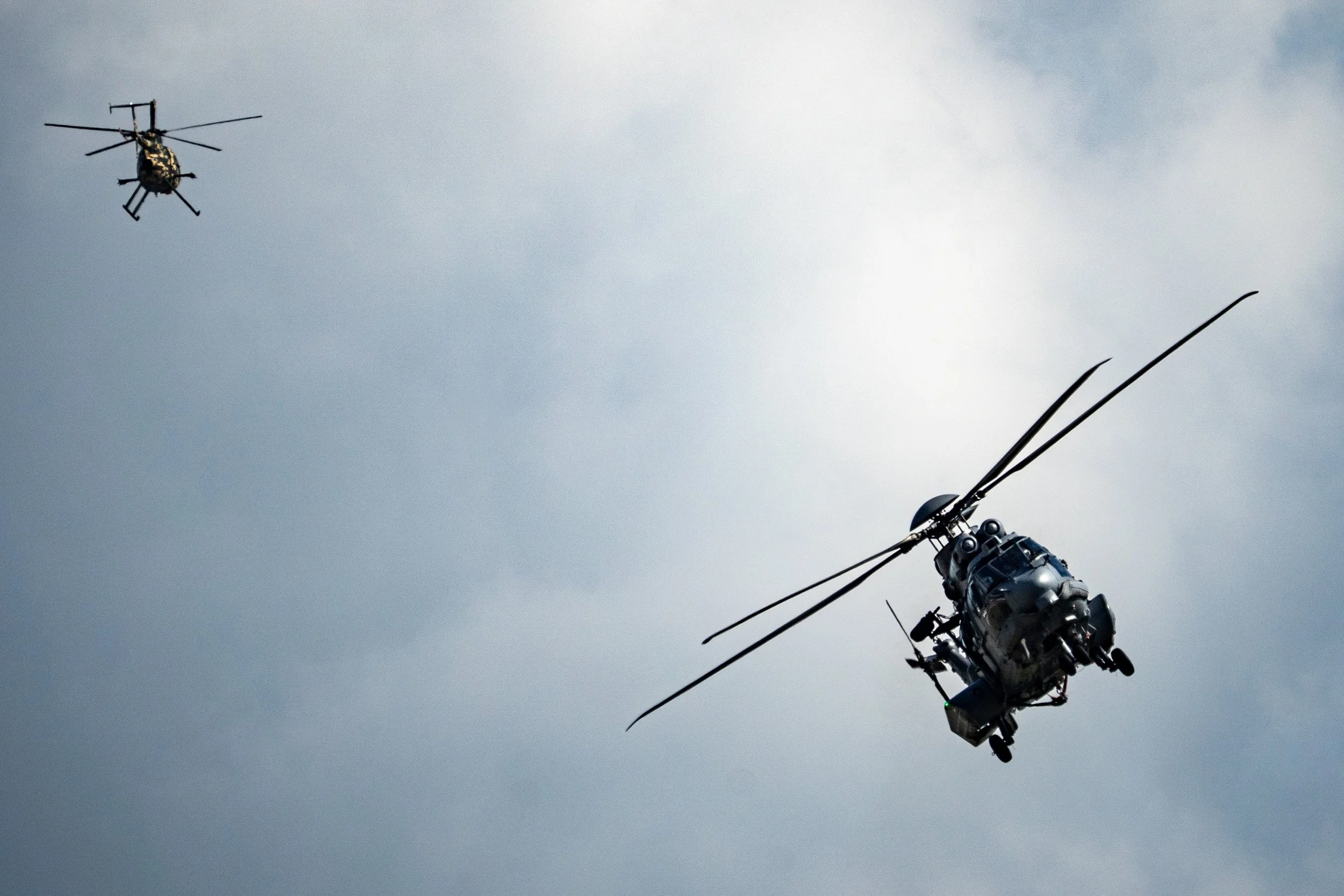 RMAF EC725 Caracal, TUDM Kuantan, Pahang — The Caracal banks hard overhead, rotor blades flexing under load against a brooding sky. Seen from directly below, the sheer scale of the machine becomes impossible to ignore.