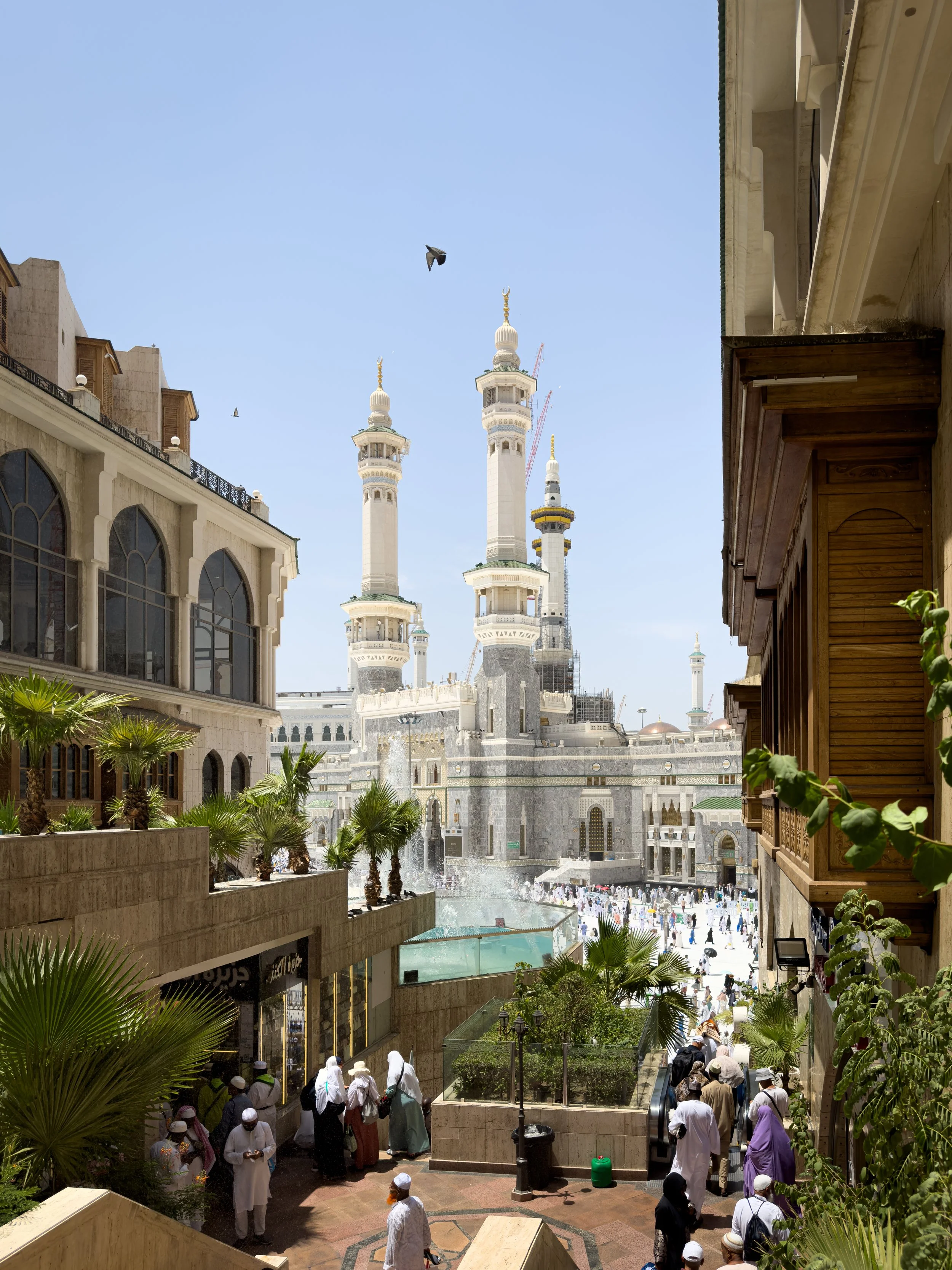 Masjidil Haram, Mecca, Saudi Arabia — The minarets rise into a clear blue sky at golden hour. Even the approach feels like arrival.