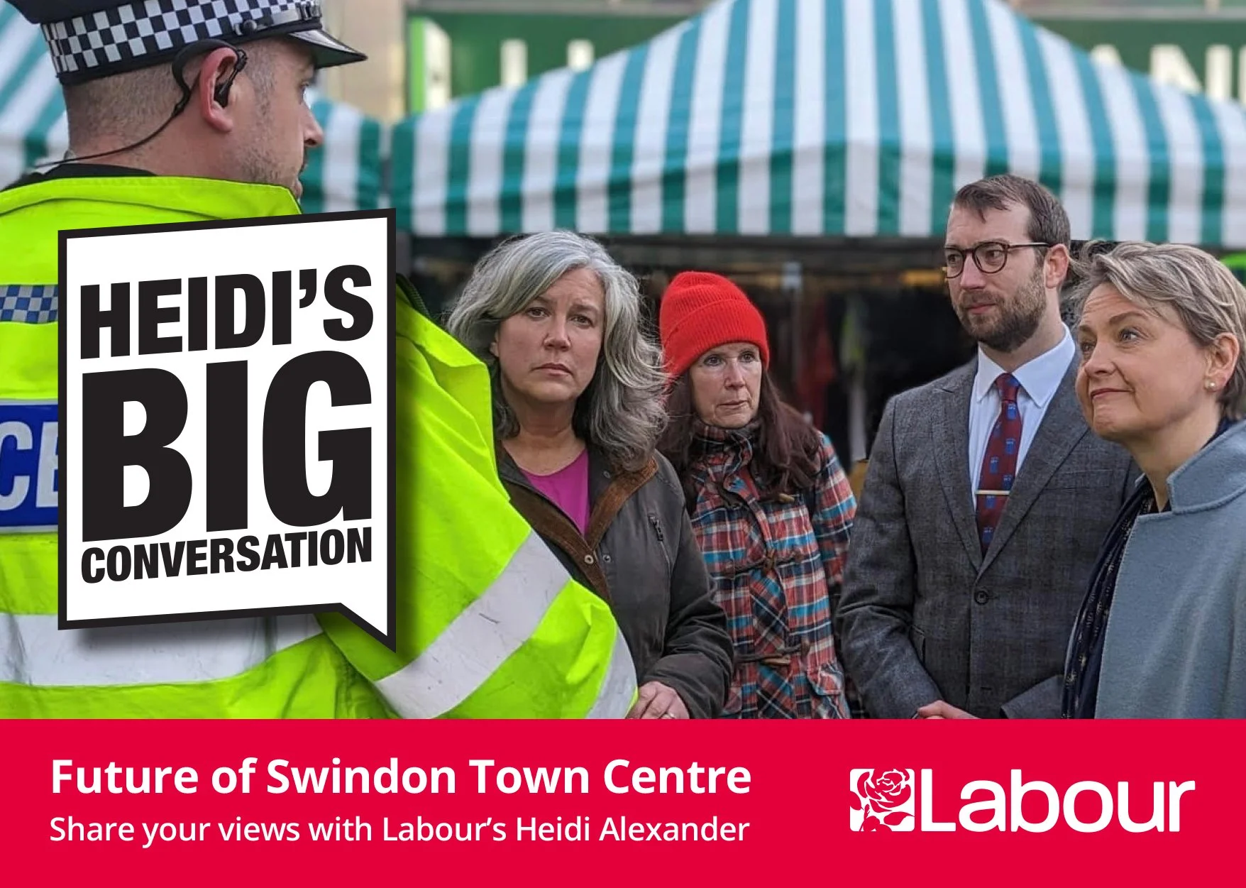 A group of people, including woman with gray hair, woman in red hat, woman with short gray hair, and man with glasses, standing in a discussion outdoors at a market or public event. A police officer in a high-visibility jacket is in the foreground. T