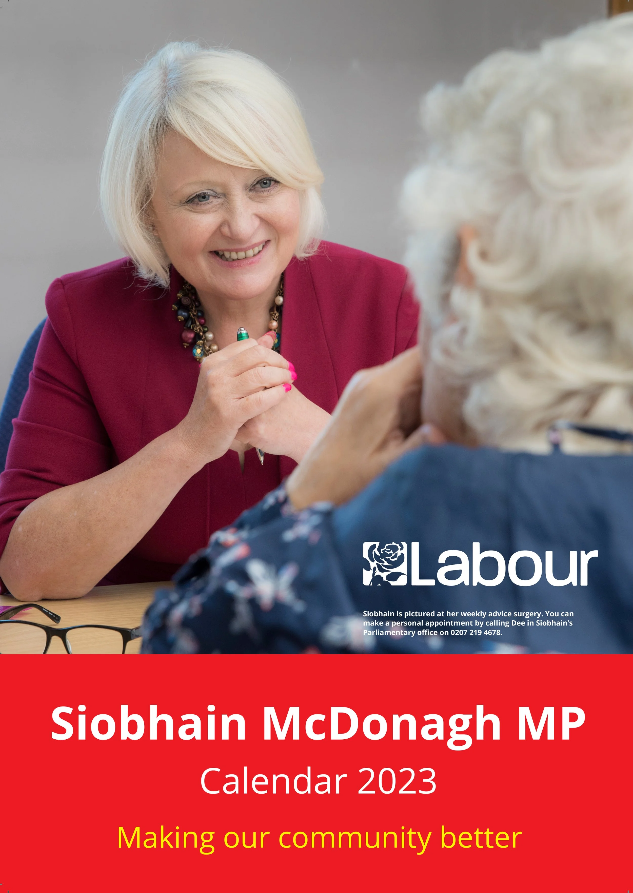 Front cover page of a 2023 calendar featuring Siobhain McDonagh MP, with a photo of her smiling and engaging in conversation, wearing a red blazer and colorful necklace, with text promoting community improvement.