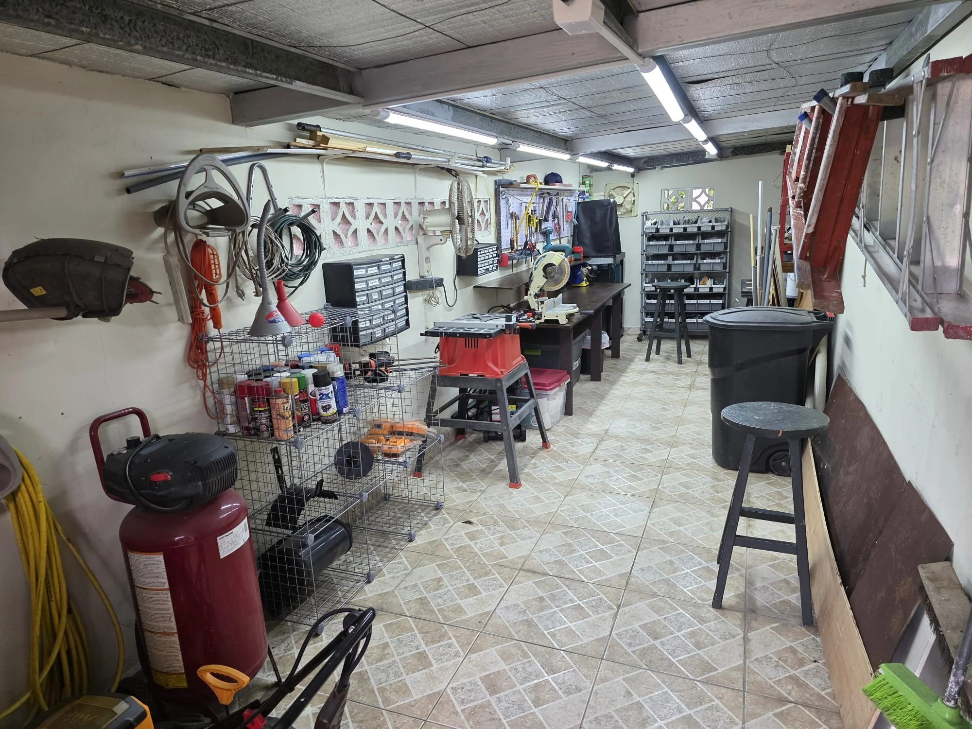 Large workshop with working saws, air compressor (for blowing up pool toys!) and many other tools