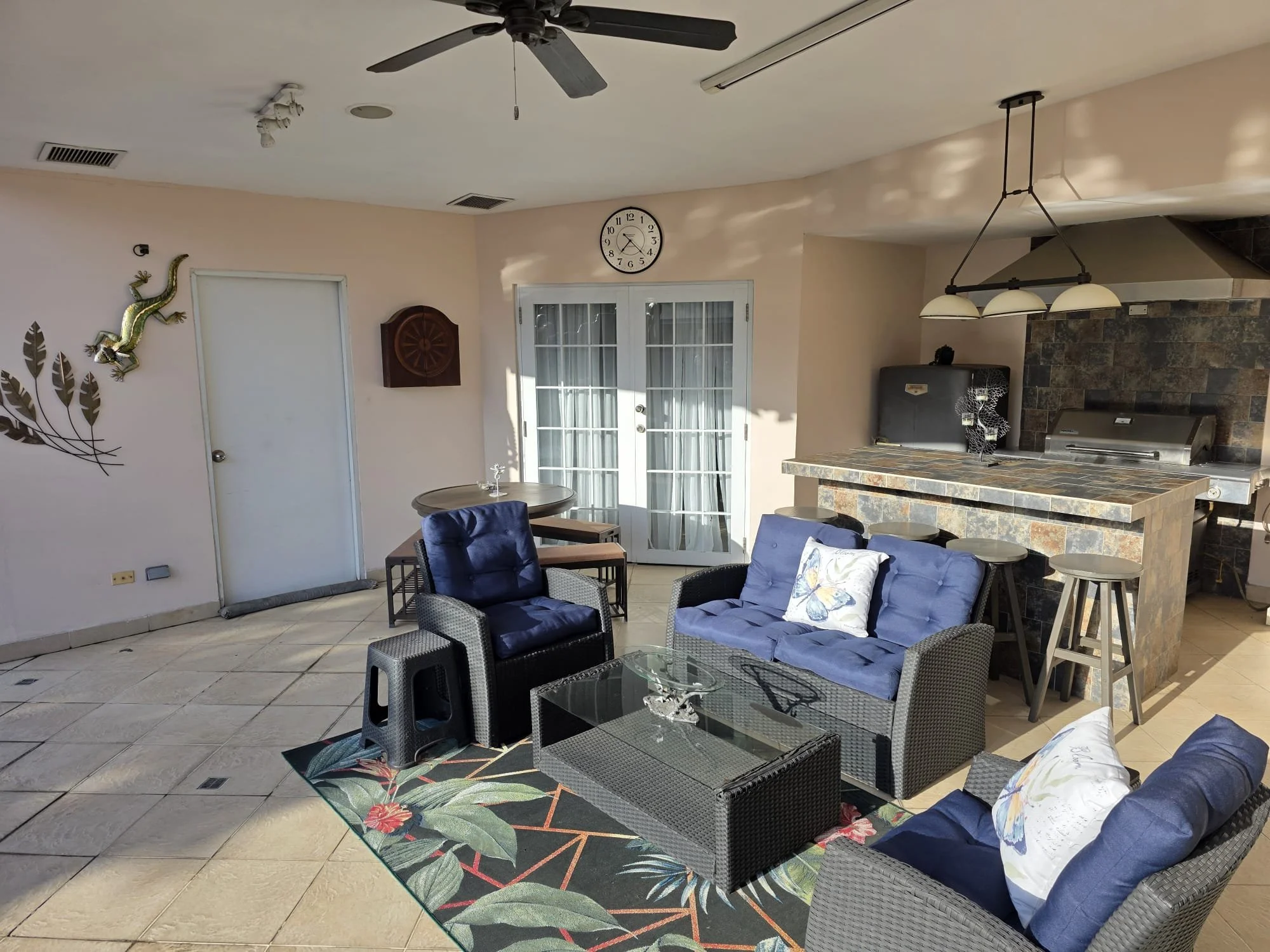 Beautiful covered patio with bar, refrigerator and barbecue.  Large pool room storage area and French doors to main bedroom