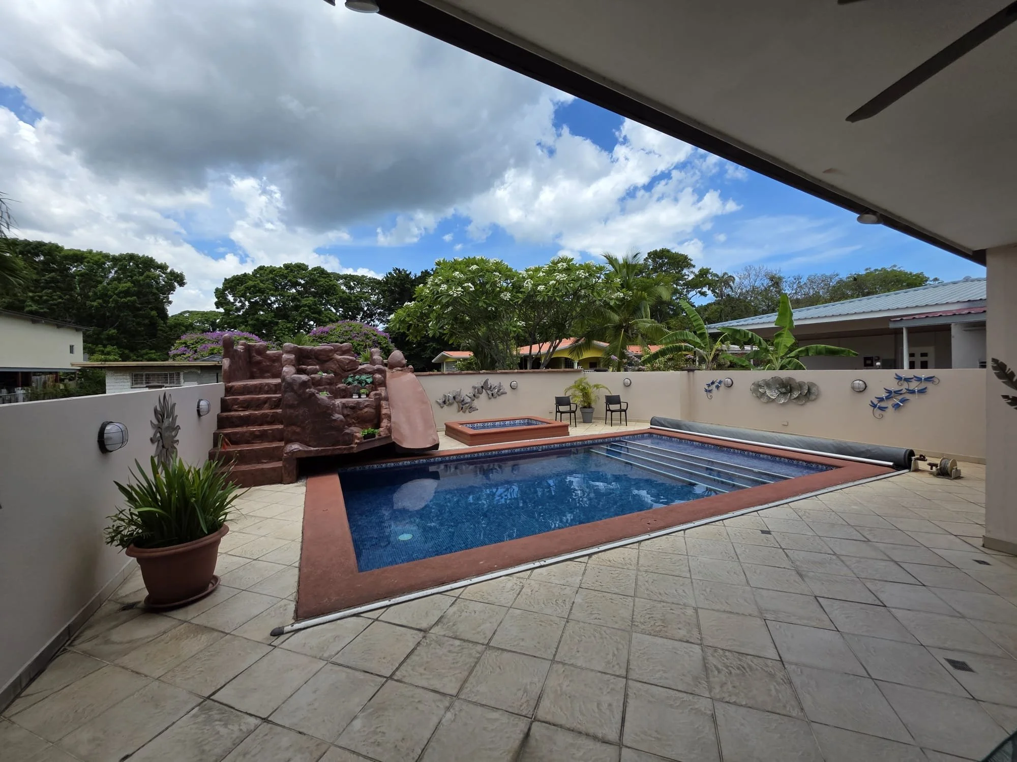 Saltwater pool with child-proof cover, waterfall and slide