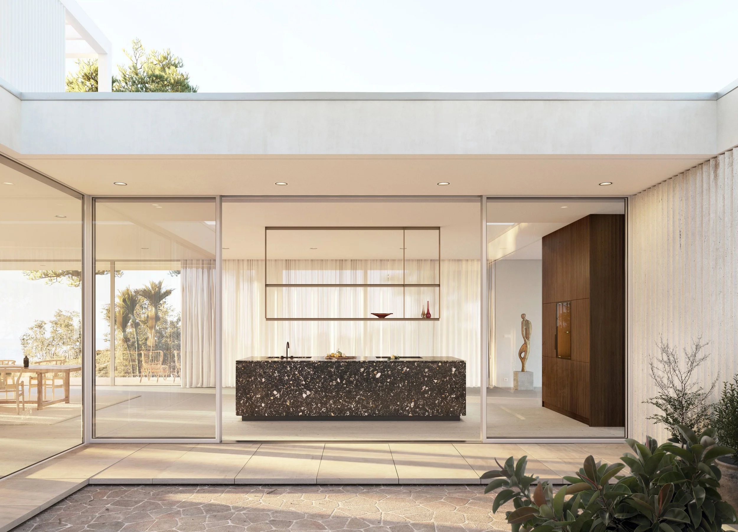 Modern open-concept kitchen and dining area with large sliding glass doors, featuring a black marble kitchen island, wooden cabinets, and views of palm trees outside.