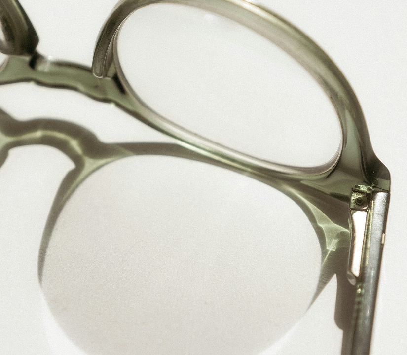 Close-up of clear eyeglasses with a white background.