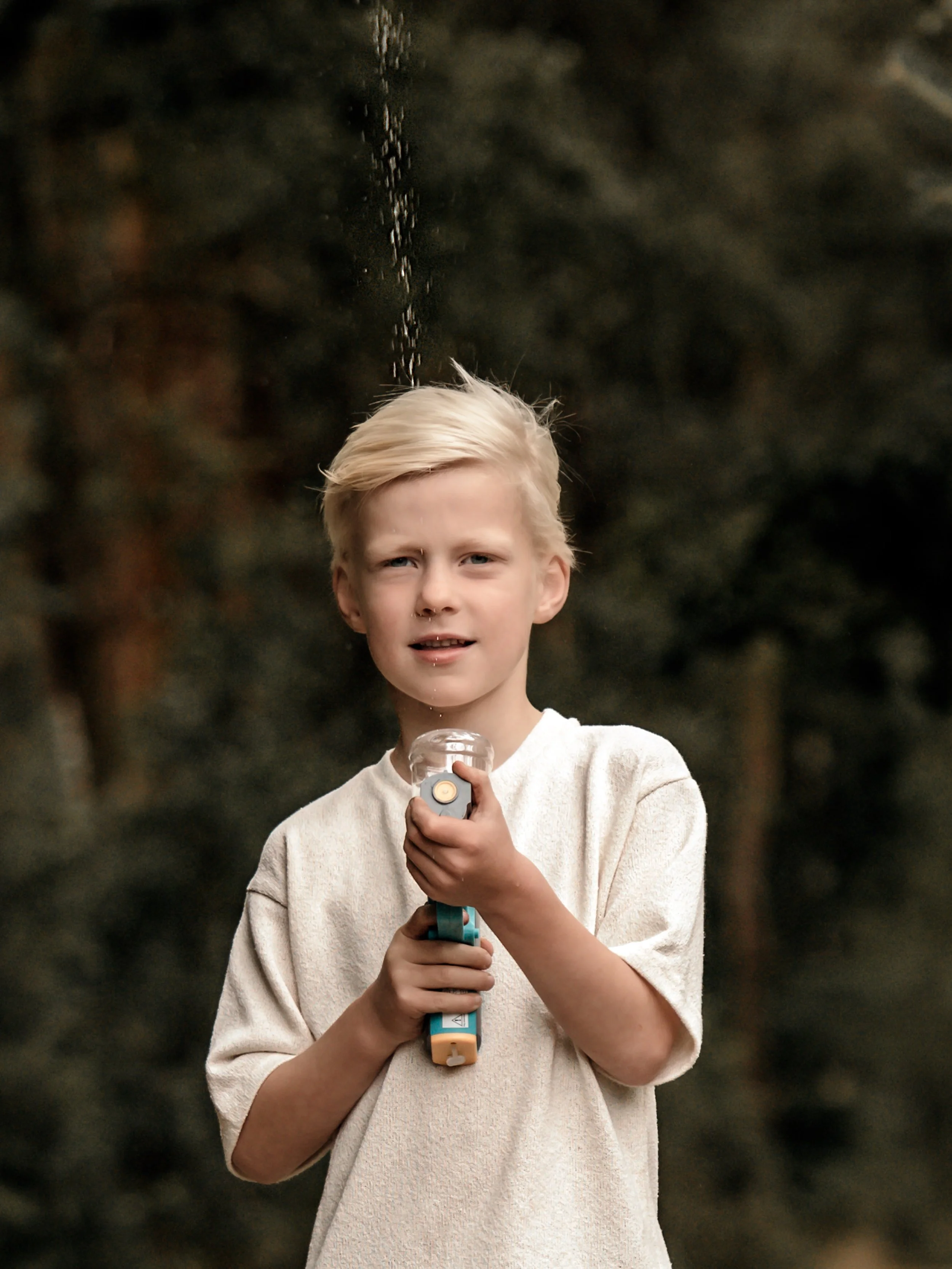 familieshoot portret jongen met waterpistool