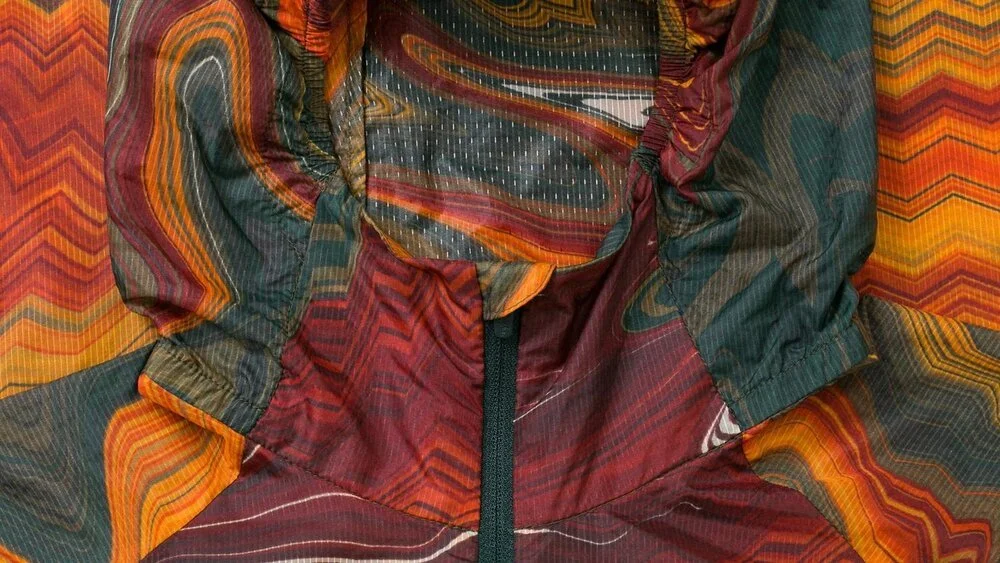 NWP01XX_MUL_H1-21_Women_s+Nomad+Wind+Jacket_Multicolour_Detail-2-Web-16x9-Final.jpeg