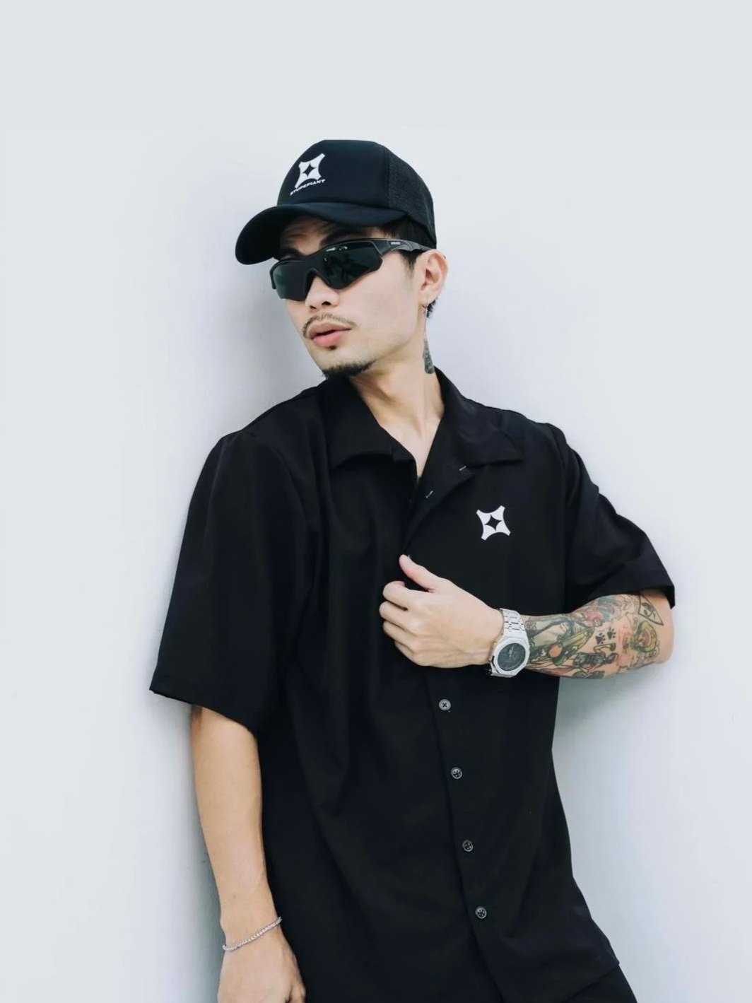 Founder of Stupefiant wearing the brand's black cap and logo shirt, featured in his client testimonial on the Huddle Design Studio homepage