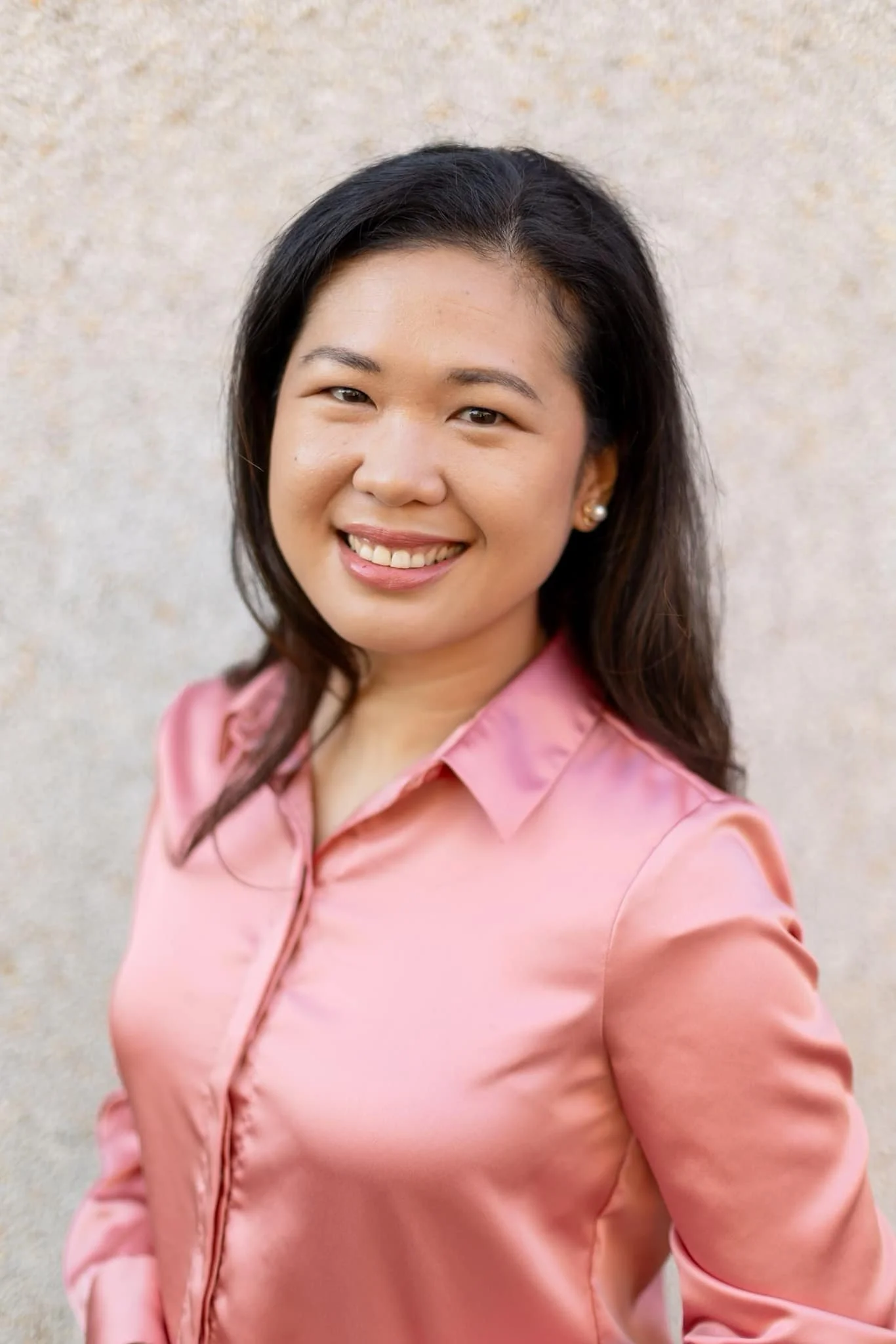Headshot of Cecille Castillon-Weinstein, founder of Pepper Concierge and The Dreamweaver Heritage Collective, smiling for her client testimonial on the Huddle Design Studio homepage