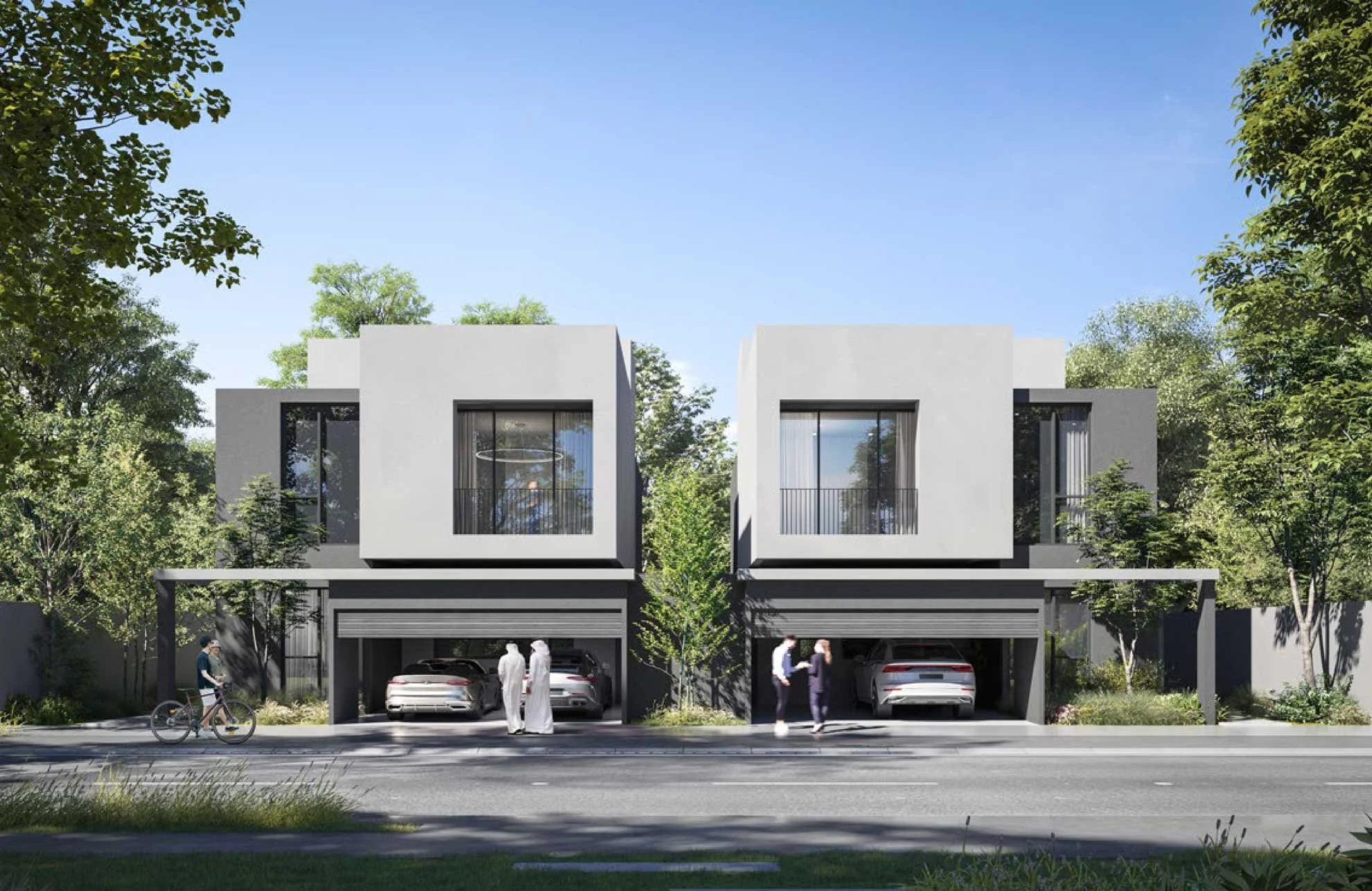 A modern residential building with two garage spaces on the ground floor, featuring a white and gray facade, large windows, and balconies. People and cars are visible outside, with trees and a clear blue sky in the background.