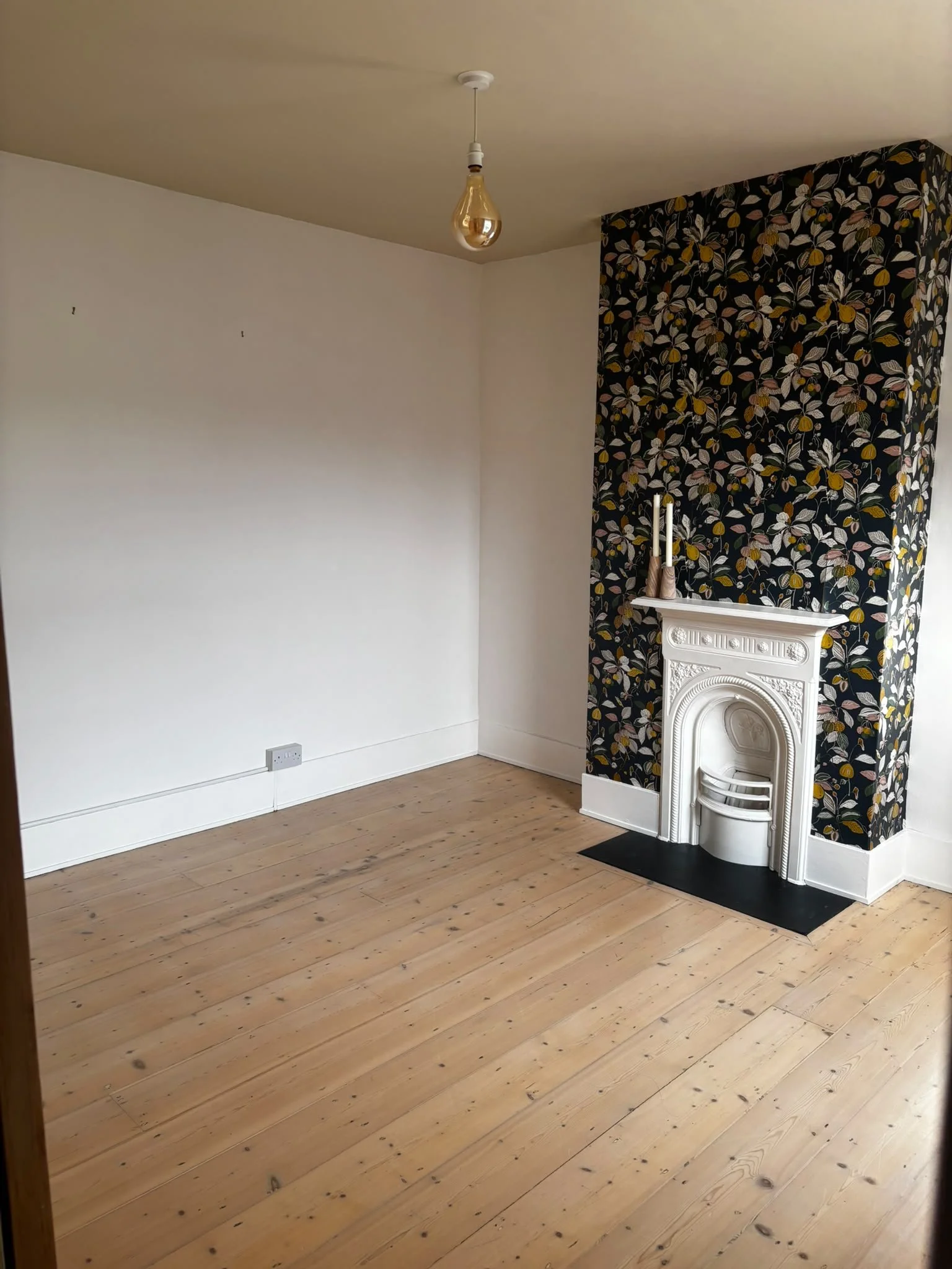 Before- bedroom with dark ceiling and wallpaper to be removed