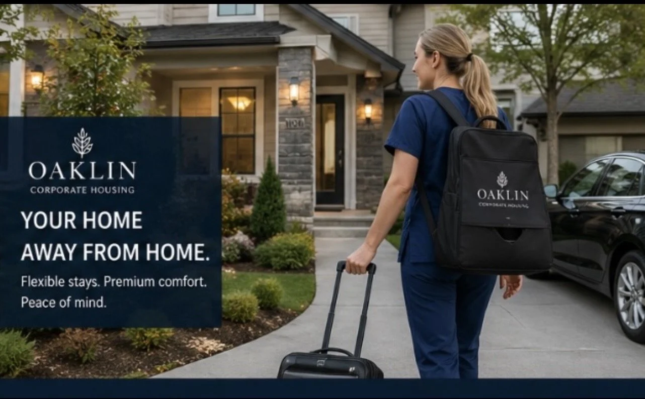 A woman in medical scrubs walking to a house with a rolling suitcase, carrying a black backpack with the Oaklin Corporate Housing logo. The house has a front porch with lights, a garden, and a driveway with a black car.