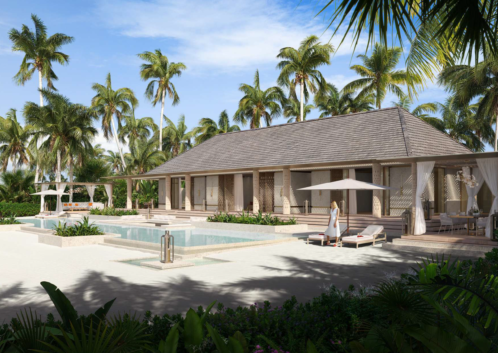 A luxurious resort with a swimming pool surrounded by lounge chairs, umbrellas, and tropical palm trees on a sunny day.