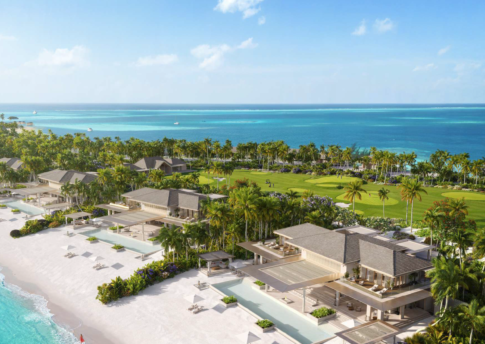 Aerial view of a beachfront resort with modern villas, a golf course, palm trees, and the ocean in the background under a partly cloudy sky.