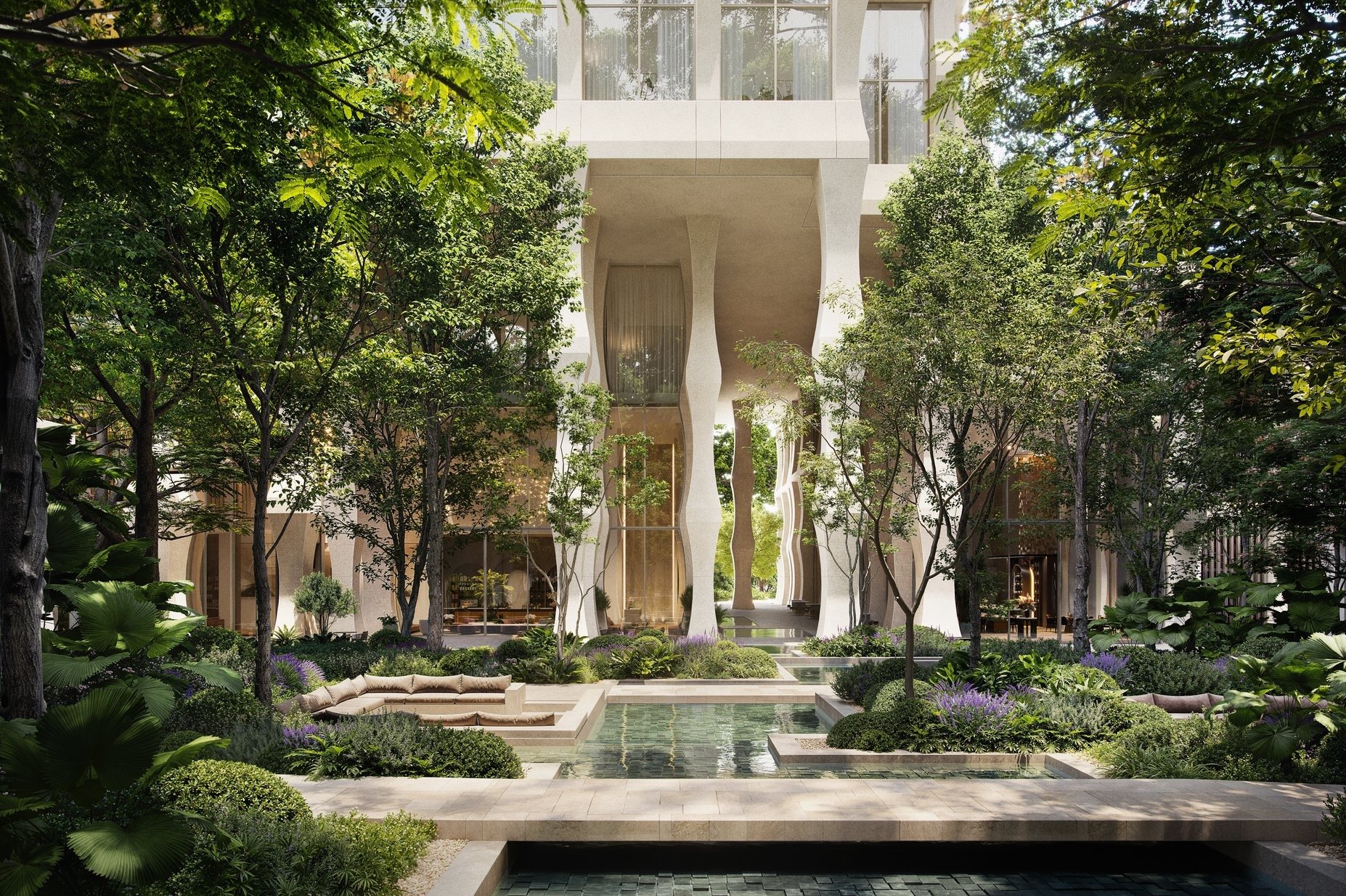 Modern building with large glass windows, surrounded by lush green trees and landscaping, with a fountain or water feature in the foreground.
