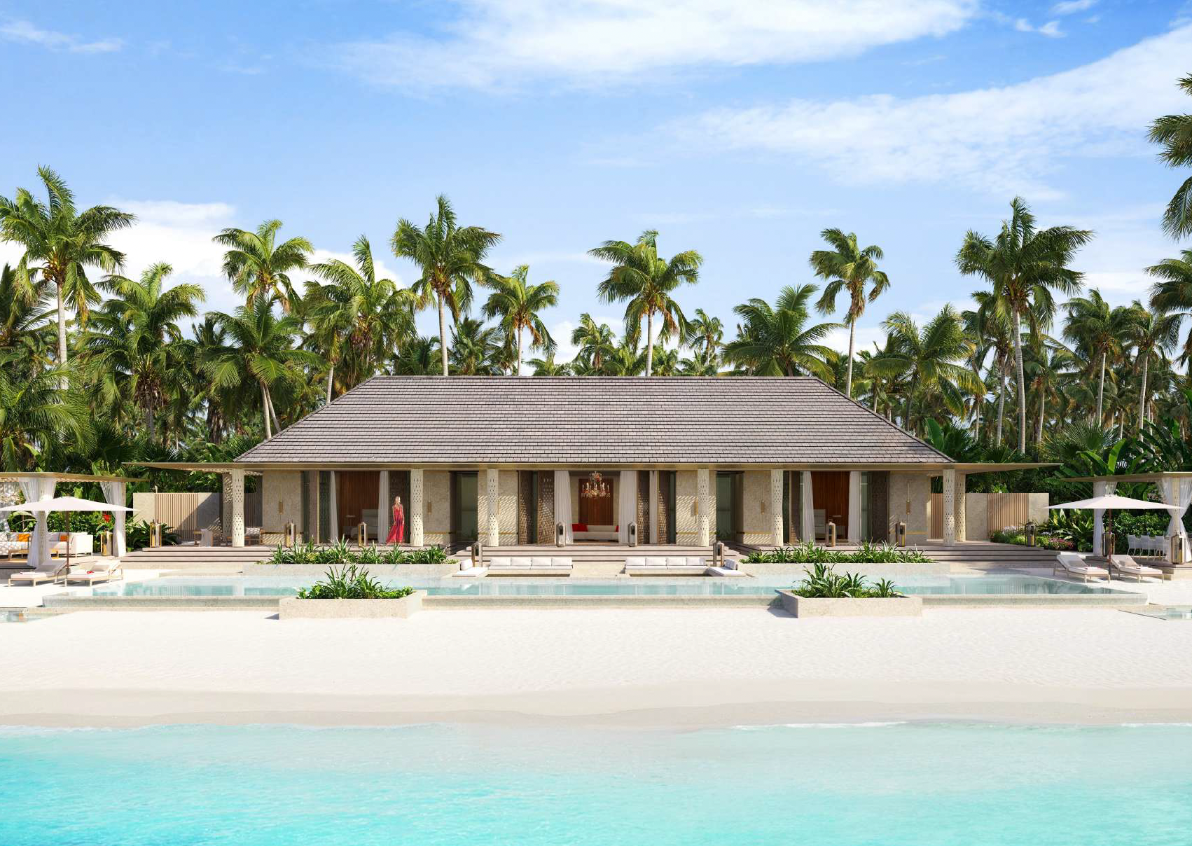 A luxury resort with a large swimming pool in front, surrounded by lounge chairs and umbrellas. Behind the pool is a modern building with a thatched roof, set against a backdrop of tall palm trees and a bright blue sky.