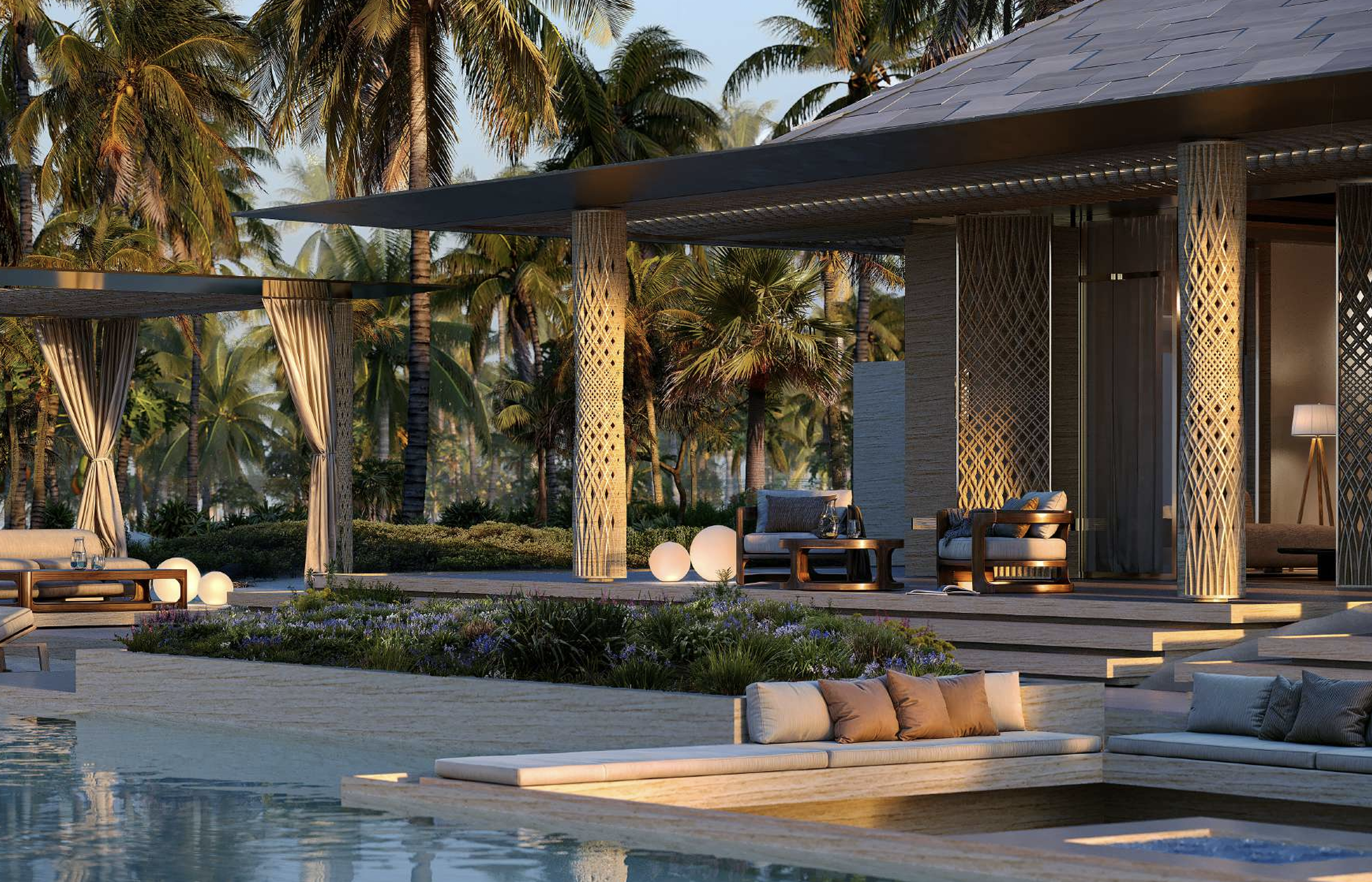 Luxury outdoor living area with modern furniture, illuminated spherical lamps, surrounding palm trees, and a pool in the foreground, during sunset.