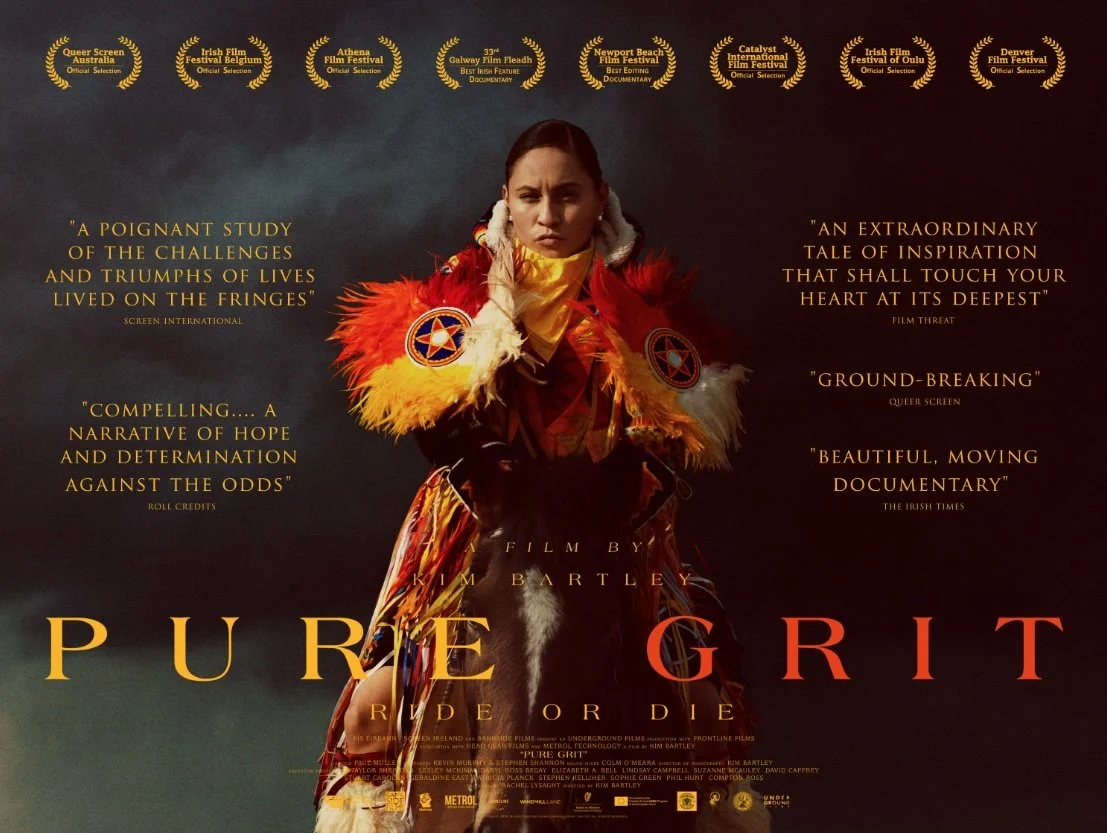 A movie poster for 'Pure Grit' featuring a woman dressed in traditional indigenous attire with colorful feathers. The poster includes quotes from reviews and film festival laurels at the top.