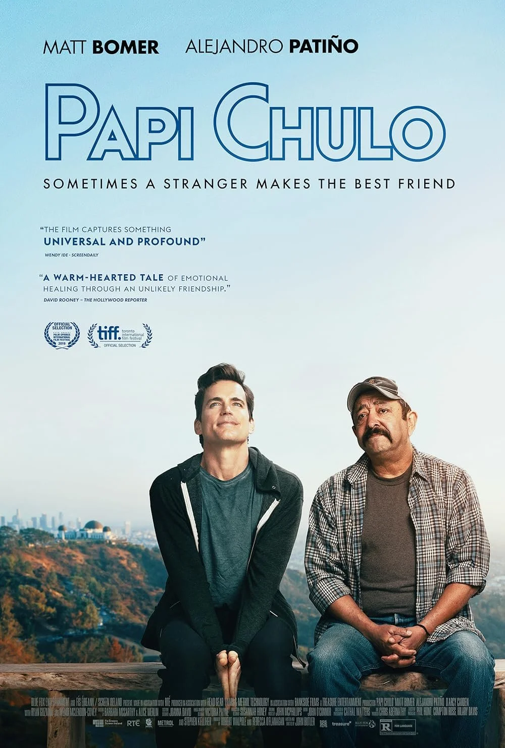 Movie poster for Papi Chulo featuring two men sitting outdoors with a cityscape and hills in the background. 