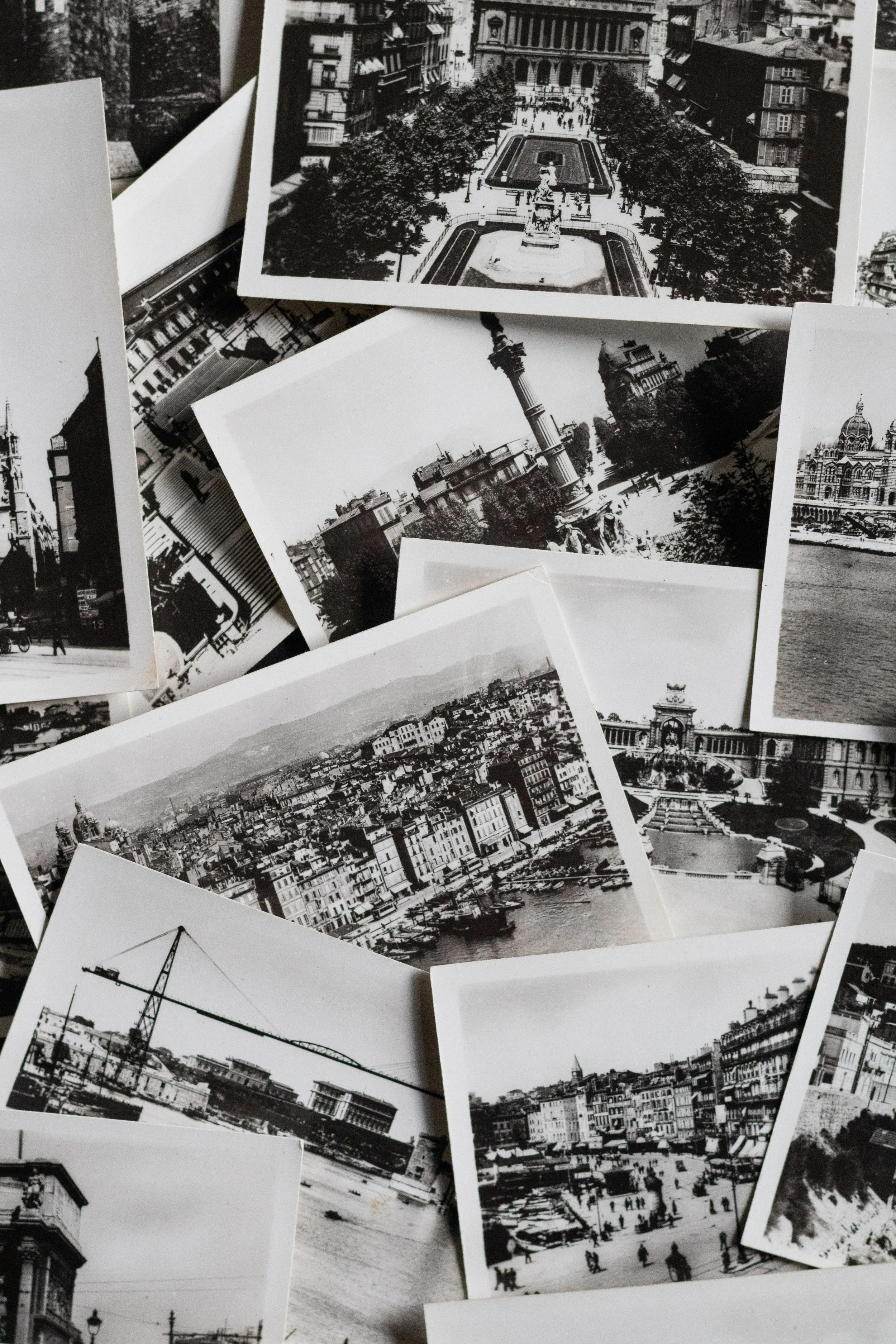 Collection of black-and-white photographs of European cityscapes and landmarks, including buildings, statues, bridges, and boats along a river.